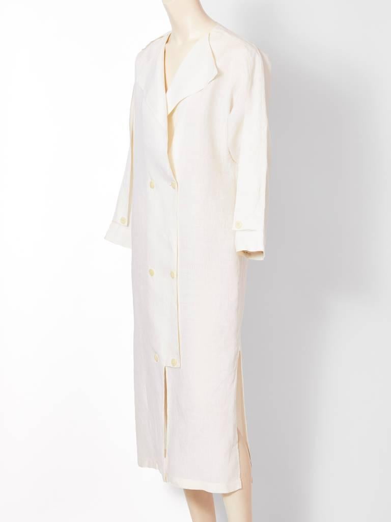Ronaldus Shamask, simple, clean line,  white linen duster/dress, with a flap lapel and double breasted closure.
