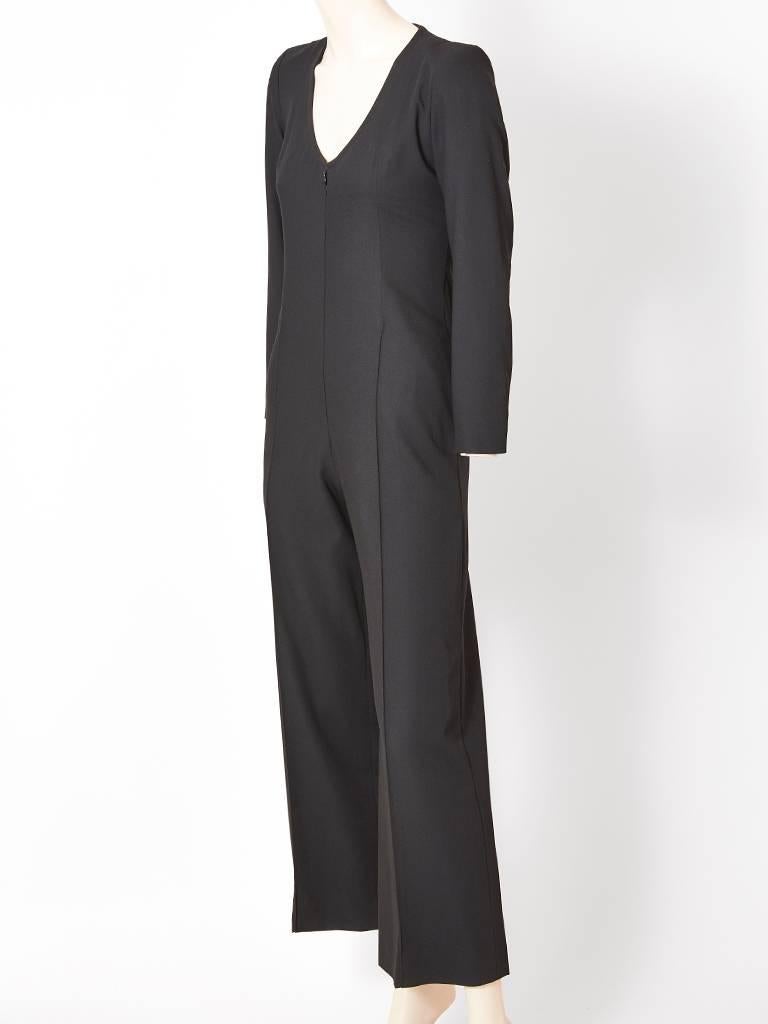 Yves Saint Laurent, Rive Gauche, fine wool, black, long sleeve, jumpsuit, having a V necline and a front zipper closure.