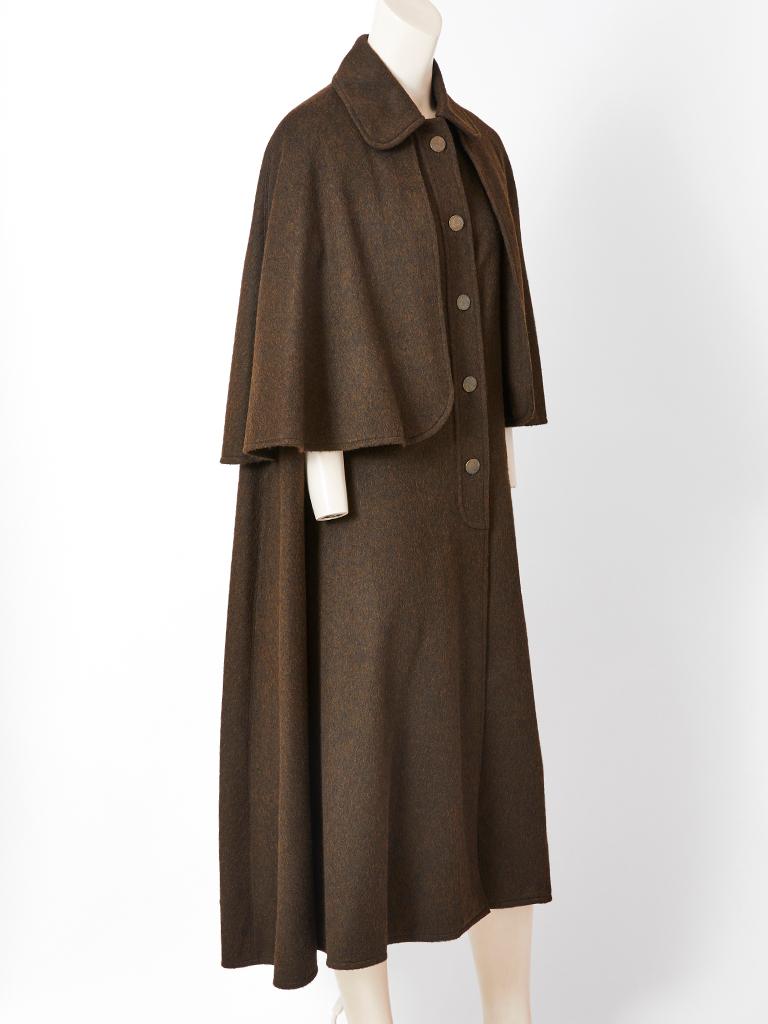 Yves Saint Laurent, Rive Gauche, olive green, wool,  long, tiered cape having a collar and a capelet over a longer cape with slits for the arms to provide freedom of movement.  C. late 70's.