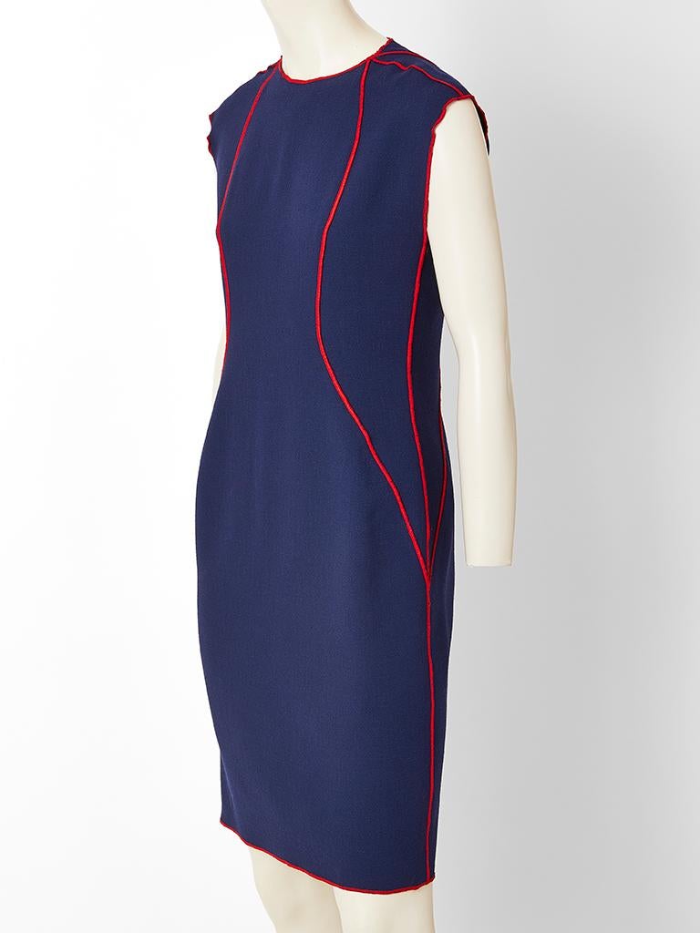 Geoffrey Beene, navy wool crepe, semi fitted day dress, having cap sleeves, a jewel neckline, and red stitching detail.