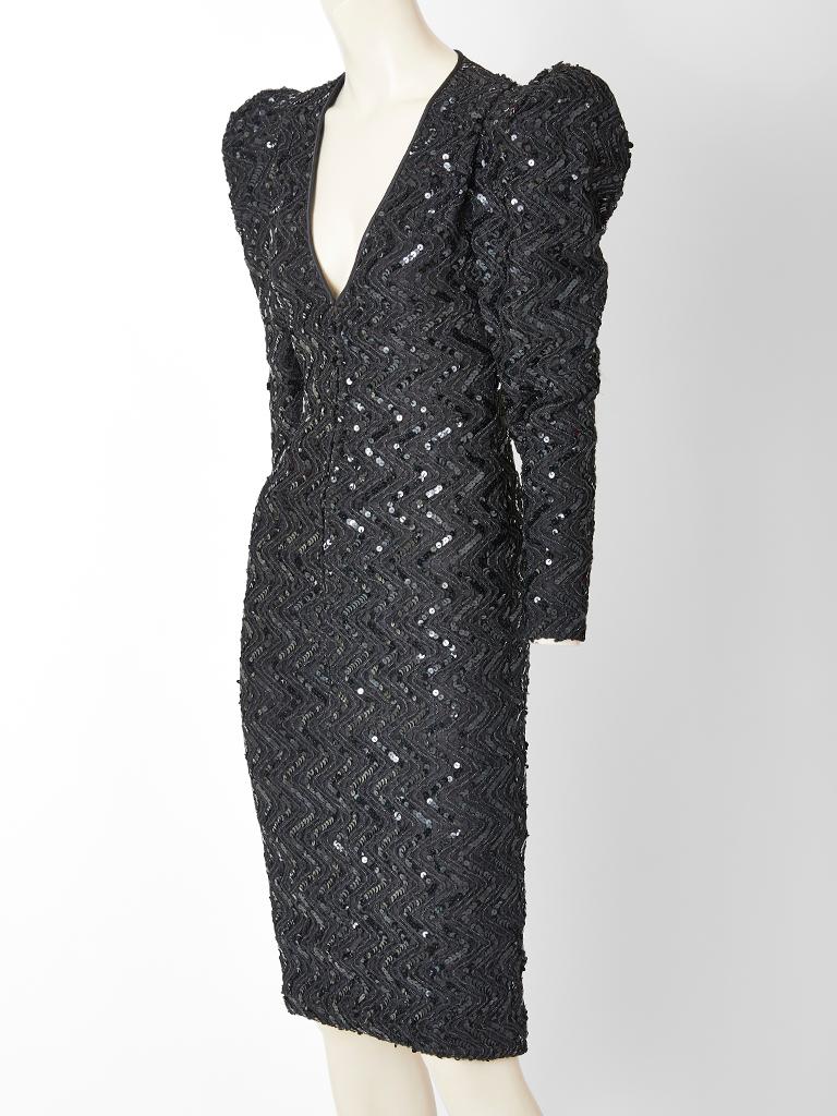 Galanos, black, crepe, bugle beaded and sequined cocktail dress having a fitted silhouette with a deep V neckline. Hidden zipper front closure.  Dress has a sheer textured tulle back detail to the waist. Sleeves are puffed at the shoulder. C. 1980's.