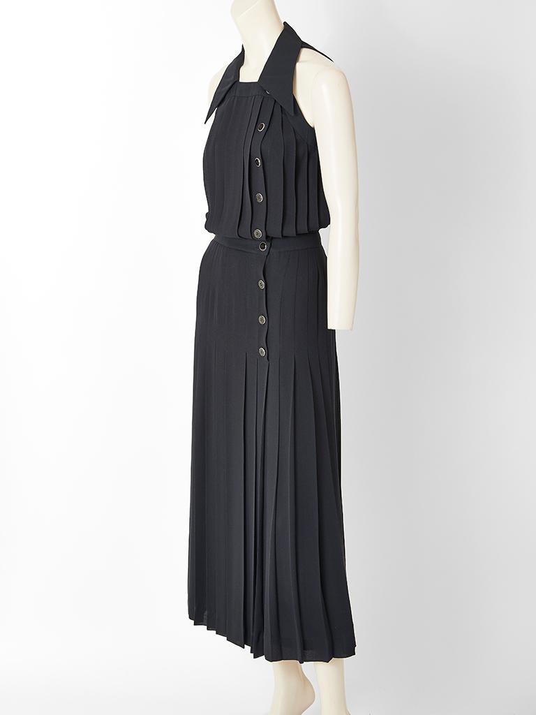 Karl Lagerfeld, black crepe, vertically, pleated maxi dress, having halter cut sleeves,  a pointed collar and  front side button closures.