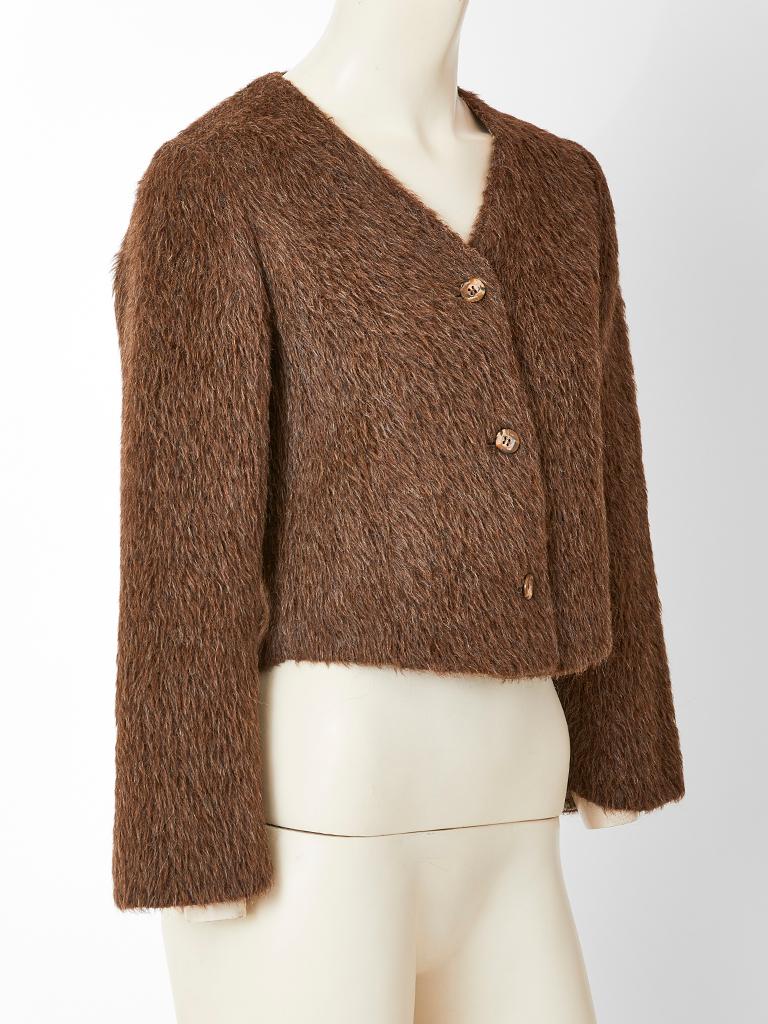 Geoffrey Beene, rust tone, mohair jacket, having a v neck with a 3 button front closure. Interior has a complementing  brown and beige tweed lining. C. Early 1980's.