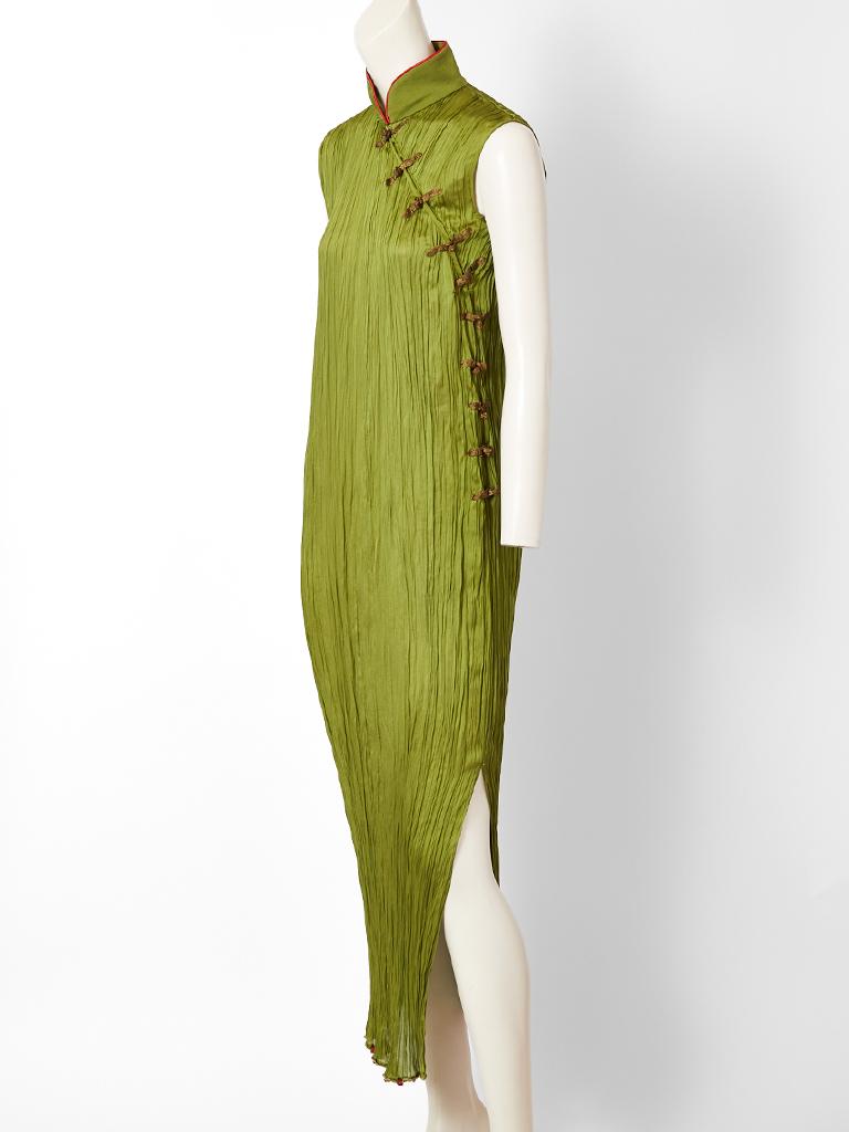 John Galliano, for Christian Dior, moss green, silk plissé, dress inspired by Mariano Fortuny and the traditional Chinese Cheongsam.  It's a successful marriage of both influences. Dress has a mandarin collar trimmed in red with gold lame side frog