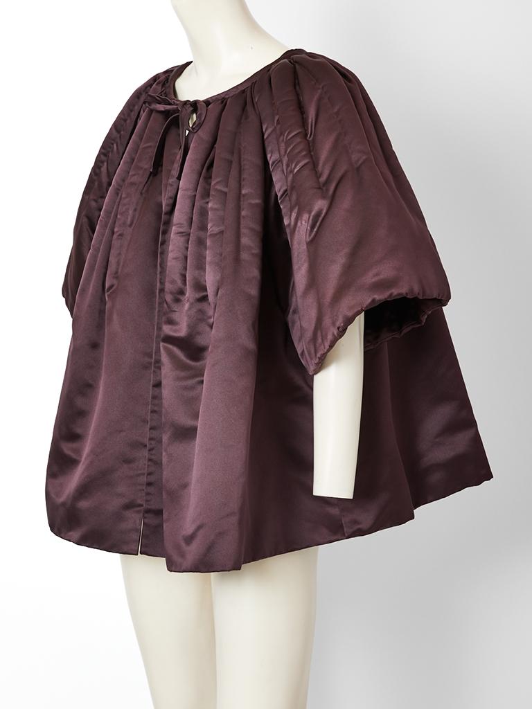 Galanos, aubergine tone, duchess satin, padded, evening jacket, having a sculpted silhouette that stands away from the body. Soft gathering at the neckline and shoulder, create a less formal 
