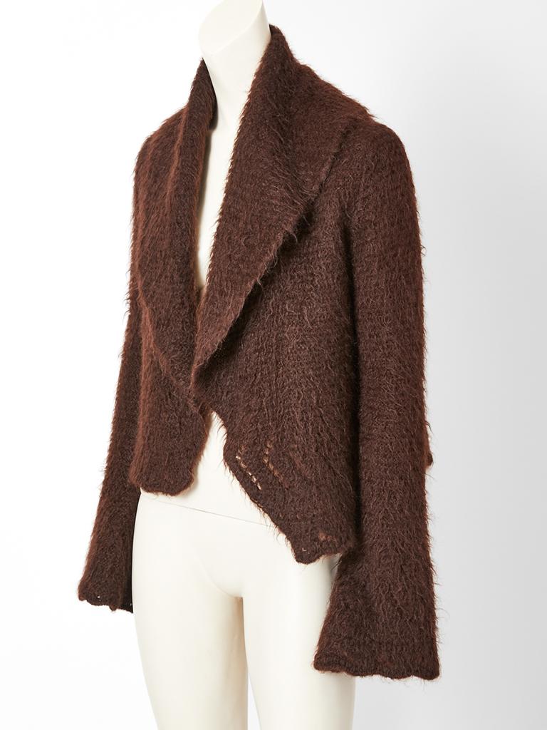 Hermès, chocolate brown, wool, mohair knit, cardigan, having an oversize, pointed collar and super long sleeves that bell at the wrist. There are no closures.... The cardigan can be worn wrapped or belted. 
The hem and sleeve edges are scalloped
