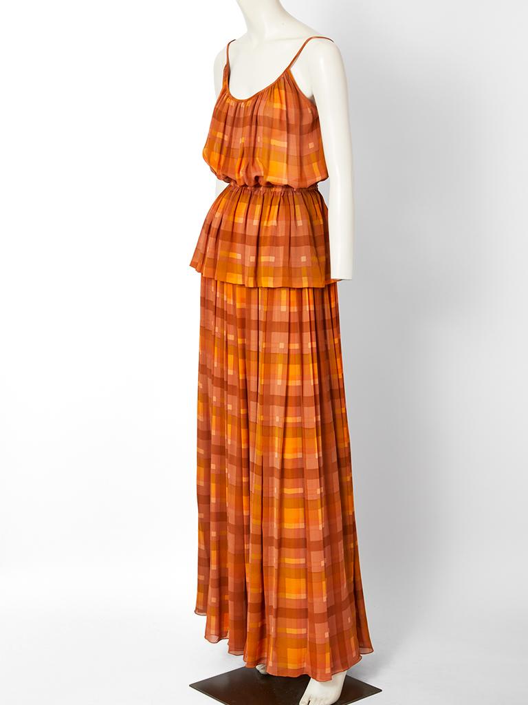 Gucci, layered, heavy georgette, rust tone, plaid, 70's maxi ensemble. The maxi skirt is gathered at the waist. The top has thin straps with gathering at the open neckline. The gathering continues at the waist where there is elastic forming a
