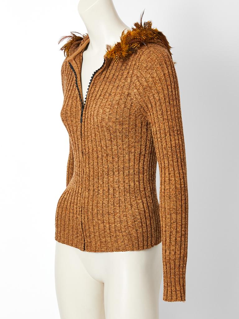 Alber Elbaz, for Yves Saint Laurent, caramel tone, ribbed , wool knit cardigan, having a front zippered closure and an attached hood trimmed in feathers.


