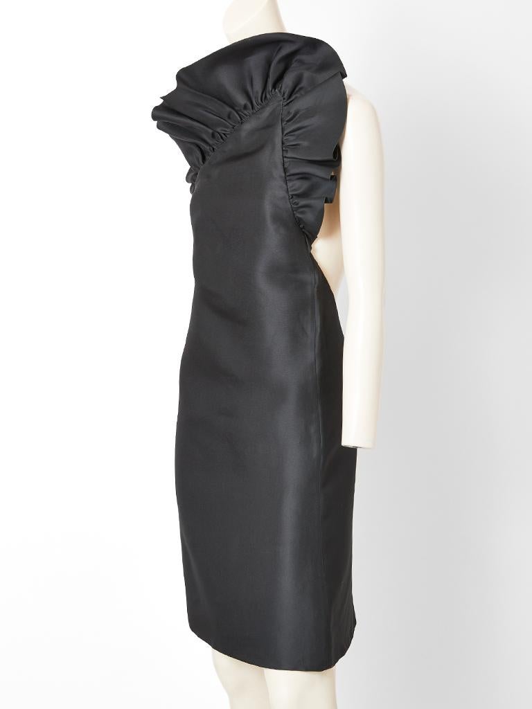 Tom Ford for Gucci, black silk gazar, one shoulder, cocktail dress having an A line silhouette with a ruffled edge across the top and under arm of the dress. Back is open in a deep U shape to the waist.
There is a single thin strap that goes