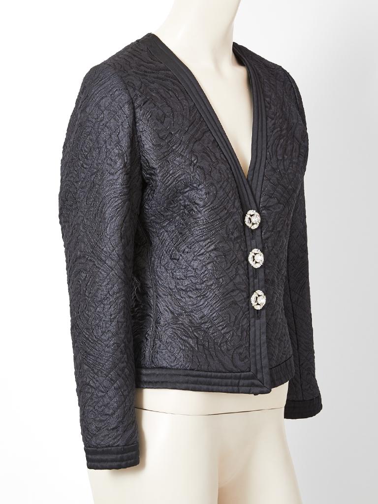 Yves Saint Laurent, Rive Gauche, fitted, evening jacket in a quilted silk. There is a deep V neck with ribbed quilting going down the center front, at the hem and also the  cuffs.  Jacket fastens with diamanté buttons.