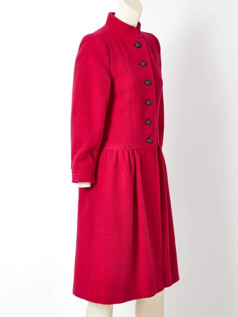 Yves Saint Laurent, Rive Gauche, fuchsia, wool princess style coat, having a dropped waist and Mandarin Collar.