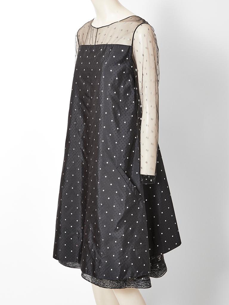 Geoffrey Beene, taffeta and dotted tulle, tent shaped, cocktail dress having a sheer neckline, sleeves and back.  The dots are in a gold lame. There are two layers of the tulle underneath the dress with an embroidered hem.