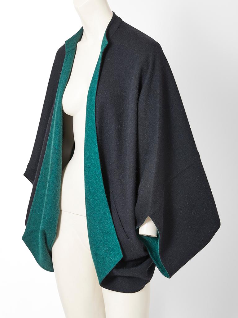 Halston, angora, double face, cocoon shaped jacket with diagonal placed side pockets. Black exterior and teal interior. Bat wing sleeves cuff at the wrist. No button closures....