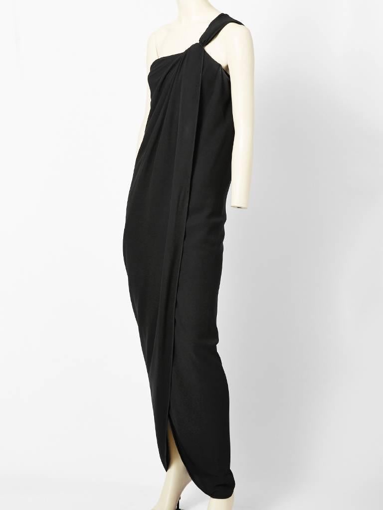 Ungaro, silk crepe, one shoulder, long sheath, evening gown. Shoulder is knotted with some gathering at the neckline draping softly down the center of the dress. Dress has a front curved panel that opens as you move. Beautifully executed dress with