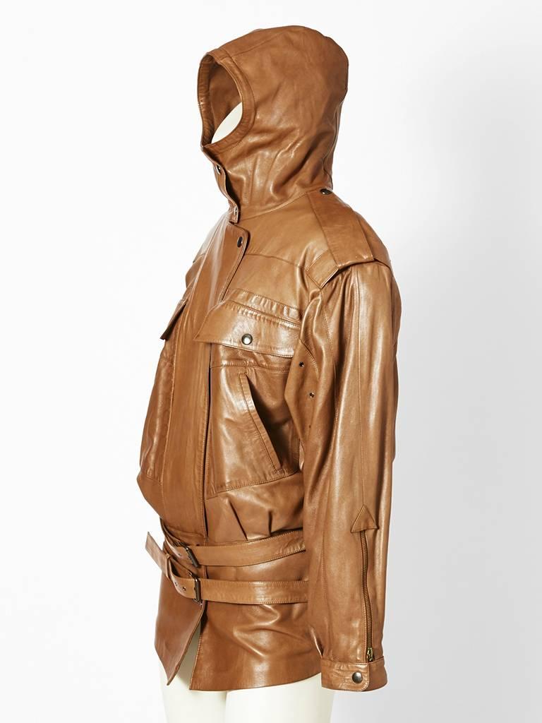 Claude Montana, brown leather oversize jacket, c.1980's. Details include, high neck, snap closures, and epaulettes. Blouson style with narrow hips and drop waist double belt.