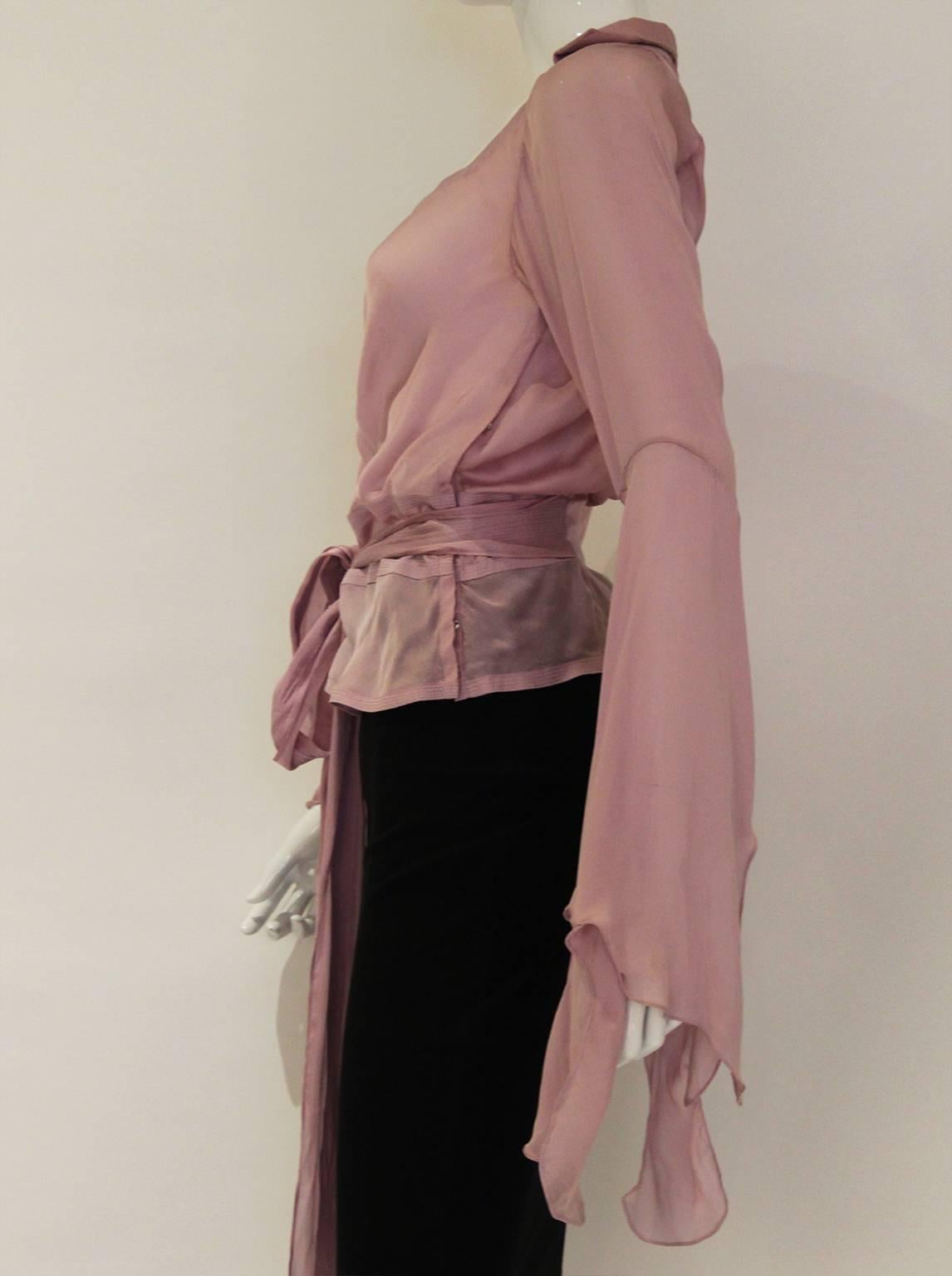 A beautiful blouse by Yves Saint Laurent, Rive Gauche, in fine lavender colour silk. This blouse has a sweetheart neckline with gathering detail and long sleeves with wonderful waterfall effect from the elbow. It also has a long tie belt that goes