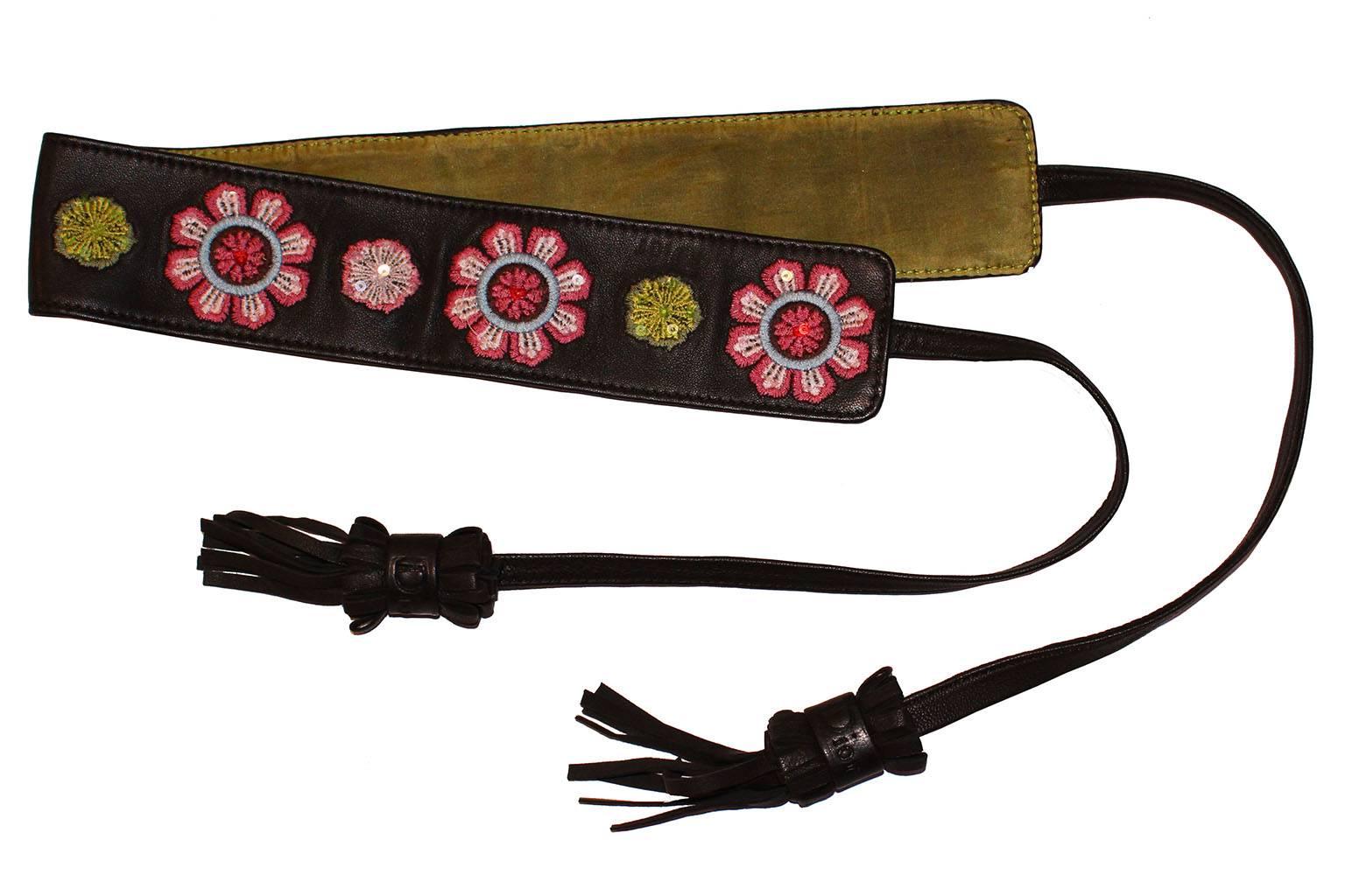 This is a great belt by Dior.The main part of the belt is brown leather, with large and small flowers embroidered onto the belt,with a few sequins added to the flowers.There is a leather tie at each end , and a tassle stamped Dior at the end of each