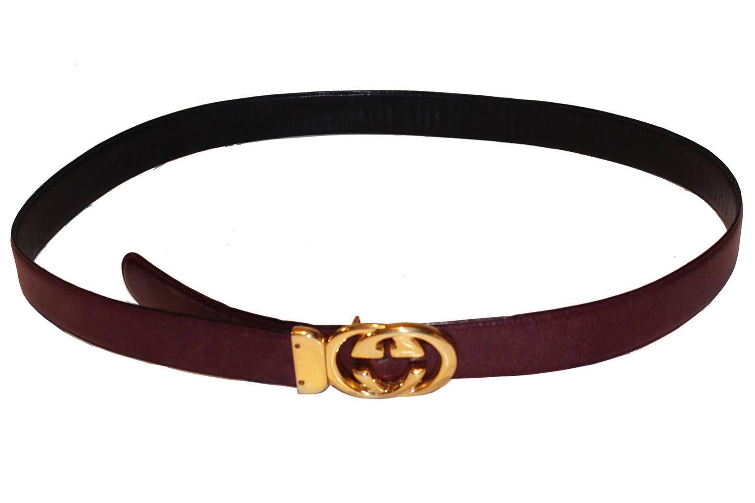 A great belt by Ieading Italian leather firm Gucci. This belt is a wonderful burgundy colour on the outside, and the inside is black leather. As  you would expect from Gucci , the leather is of a high quality. The 'gold' buckle is stamped - Gucci -