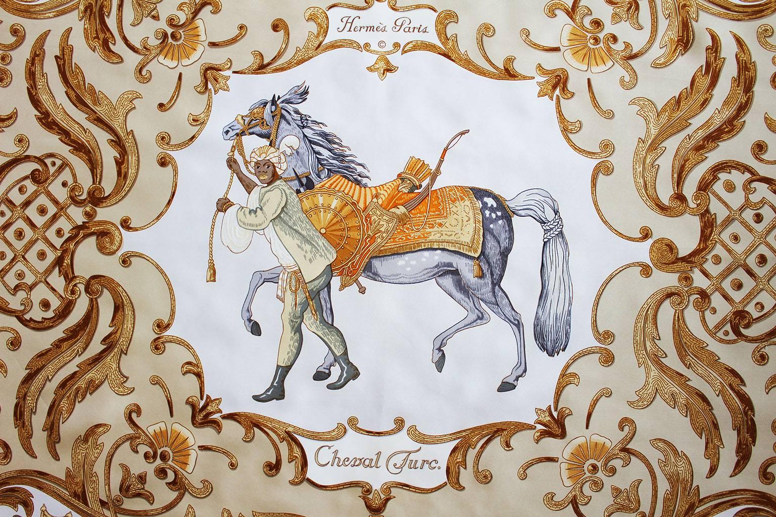 A superb silk scarf by French firm, Hermes , Paris, This scarf is the Cheval Turc design.The borders are  a soft gold colour, and the body of the scarf is dark gold, grey,orange and ivory.As you would expect from Hermes,the silk is of a high quality