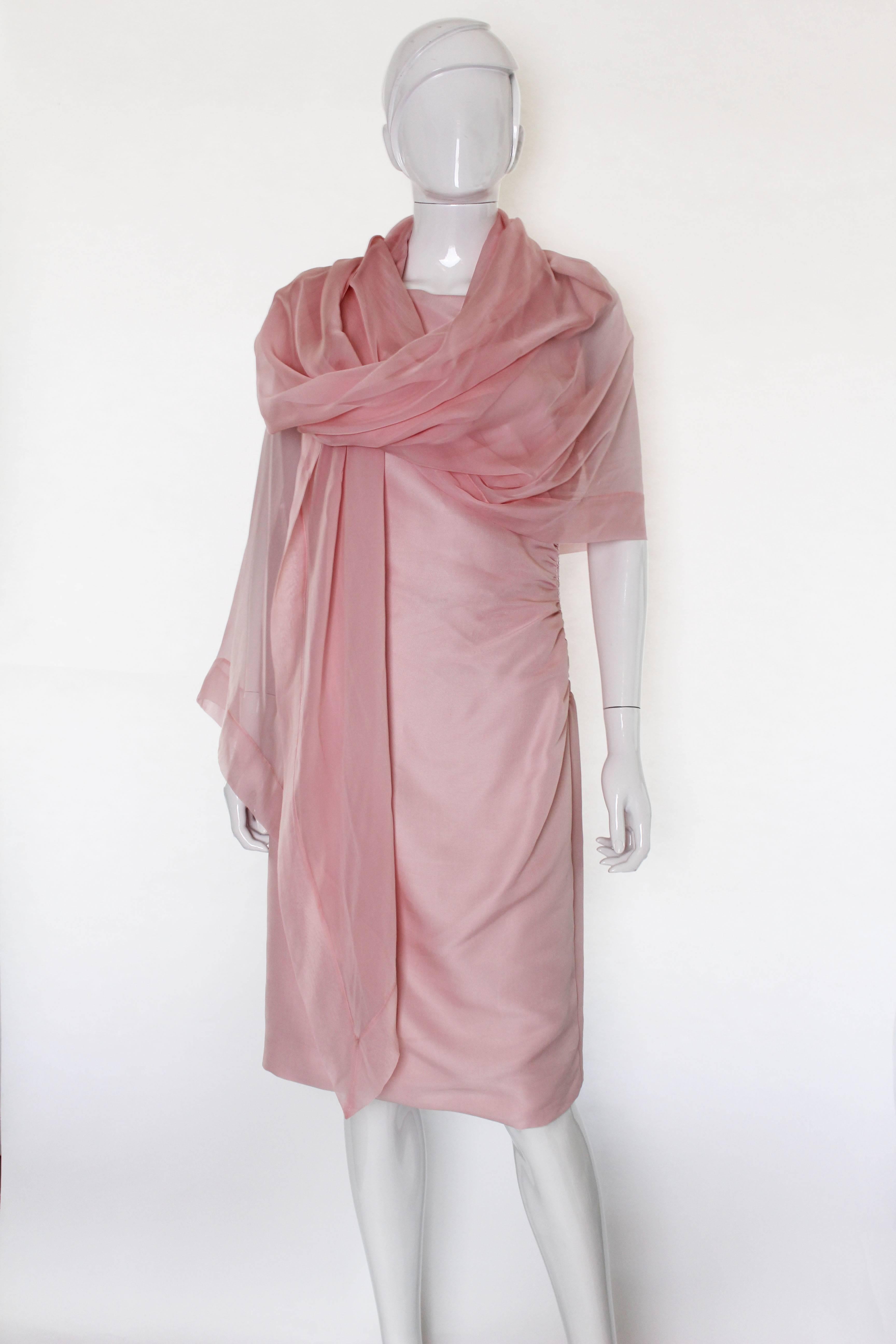 This blush silk Valentino cocktail dress is a lovely piece with some great detailing. It is an asymmetric design, with different straps on either shoulder. One side has a beautiful fan shaped bow draped from front to back, with the other is a simple