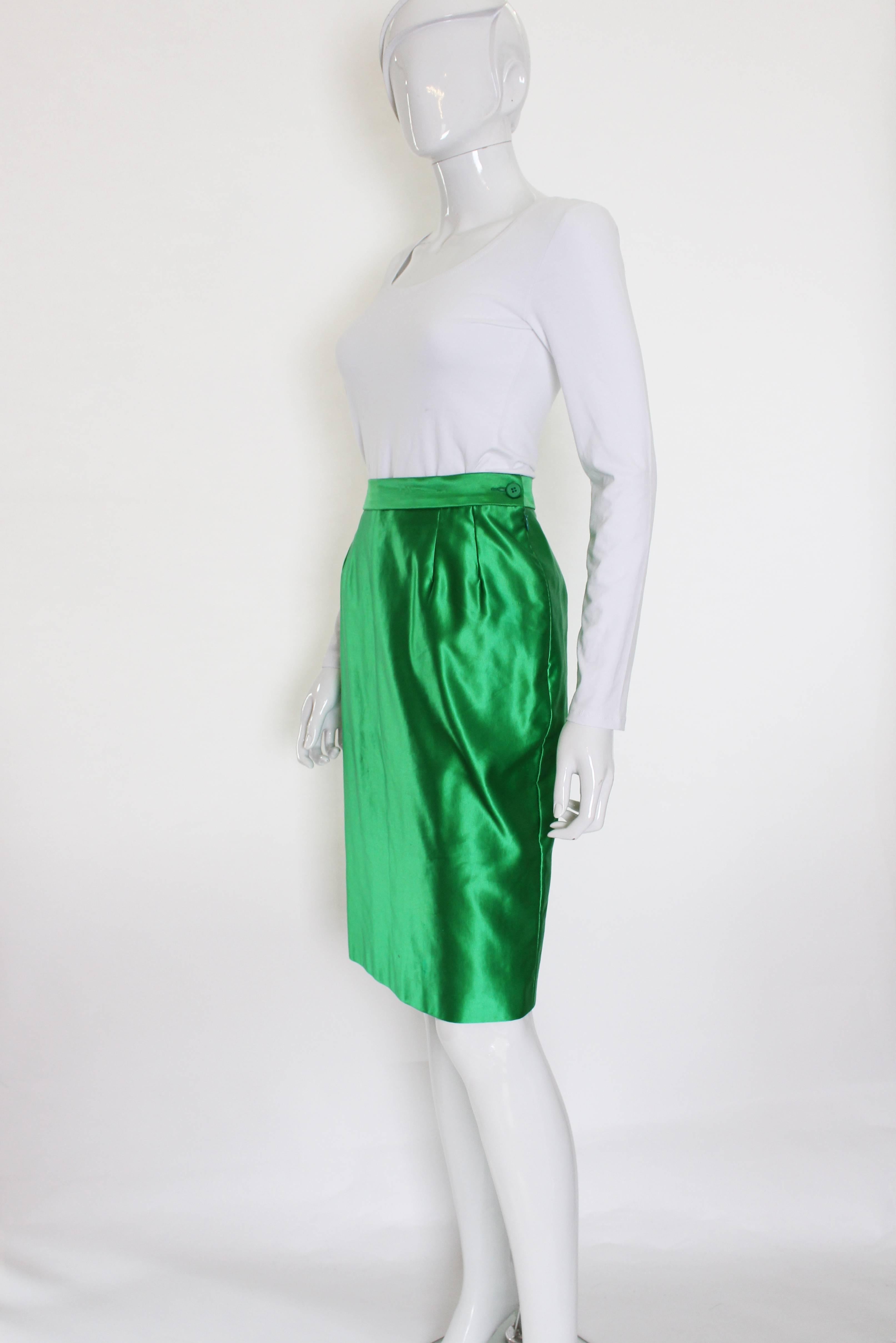 A great green skirt from Yves Saint Laurent,Variatio line.
This skirt is a wonderful colour ,and in a great fabric being, 70% cotton, 30% silk.The skirt has a side zip opening,and a 6'' slit at the back.


