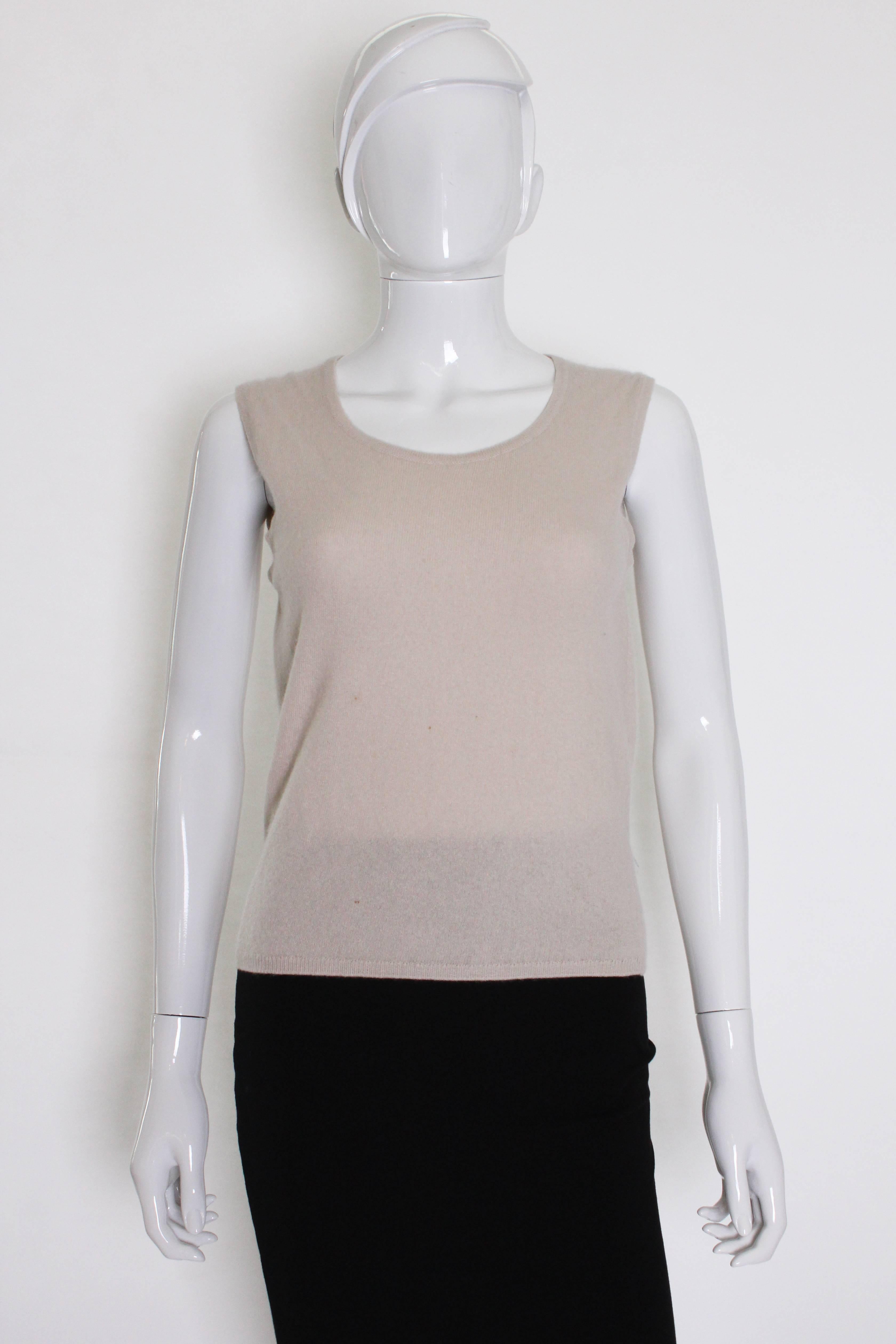 A useful and luxurious knit from Chanel. As you would expect the cashmere is super soft, and in an elegant ivory colour. The tank has a scoop neck.