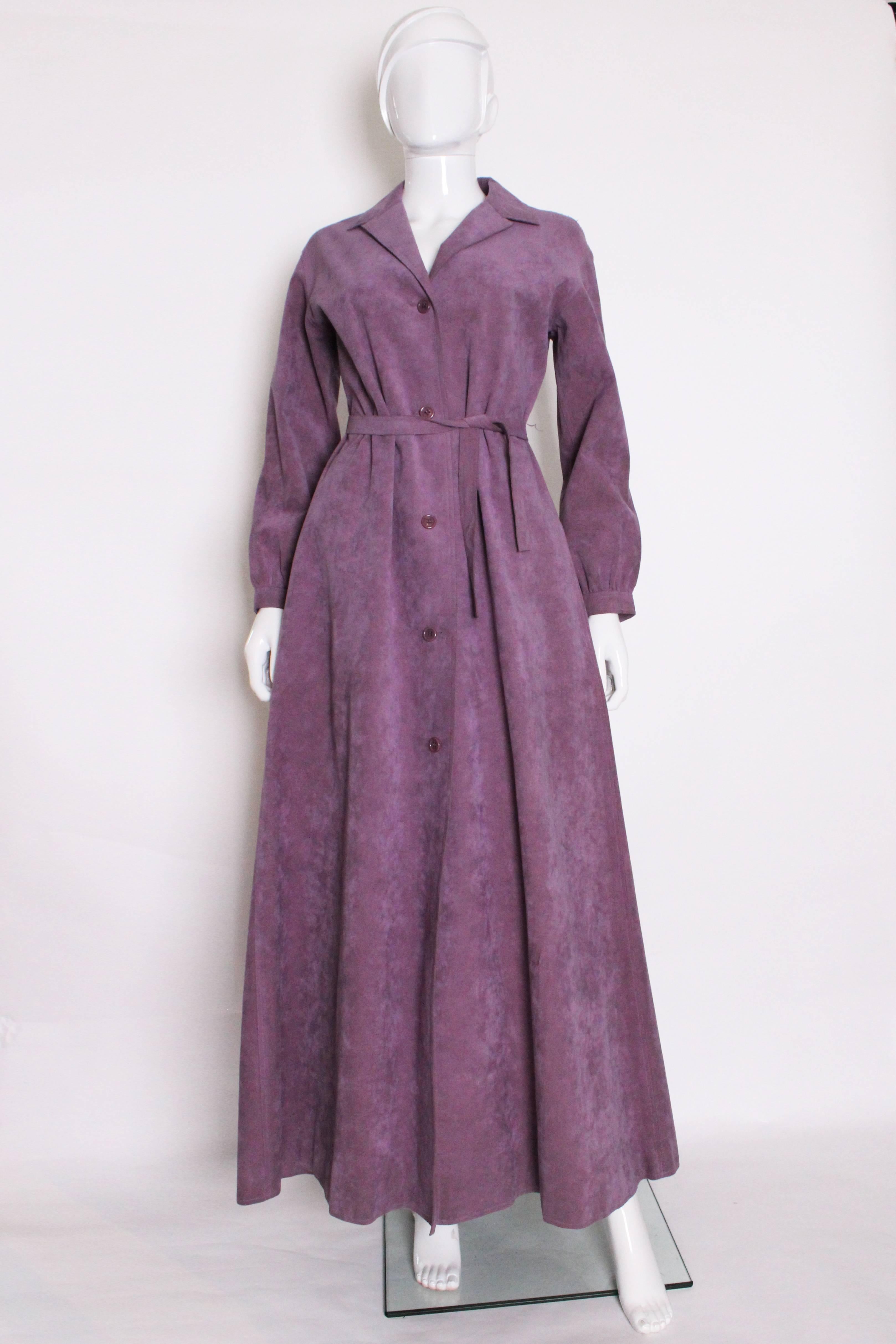 A great dress coat by 1970s style icon Halston. In lavender ultrasuede, this full length dress coat can be dressed up or down, and worn buttoned or unbuttoned. The sleeves are gathered into a narrow cuff, and there is some gathering on the back.