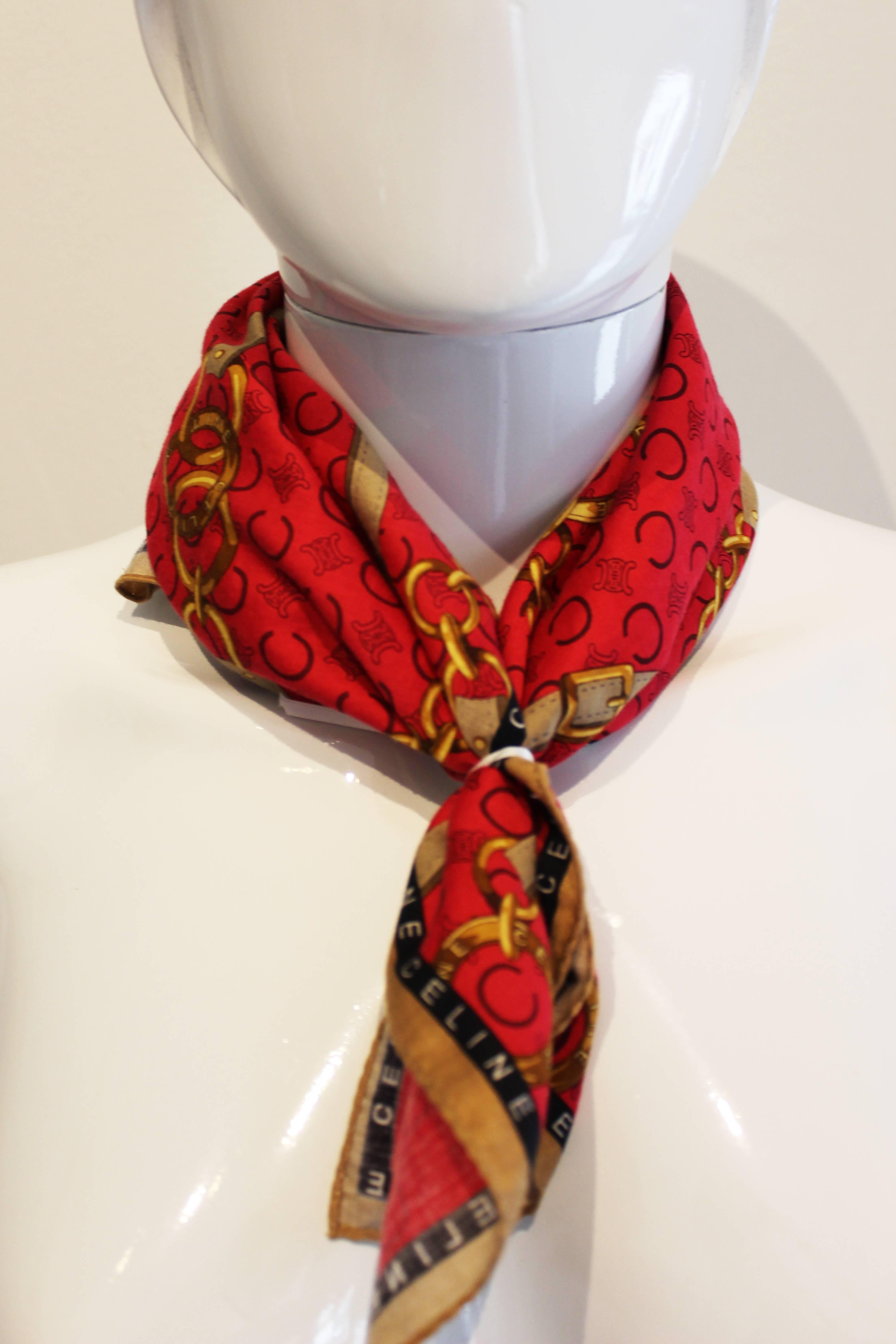 A super little scarf for Summer by French house of Celine. This scarf has a biscuit coloured border,with an inner black border with Celine printed on it.
The body of the scarf is a deep raspberry pink colour, with the letter C, Celine logo and