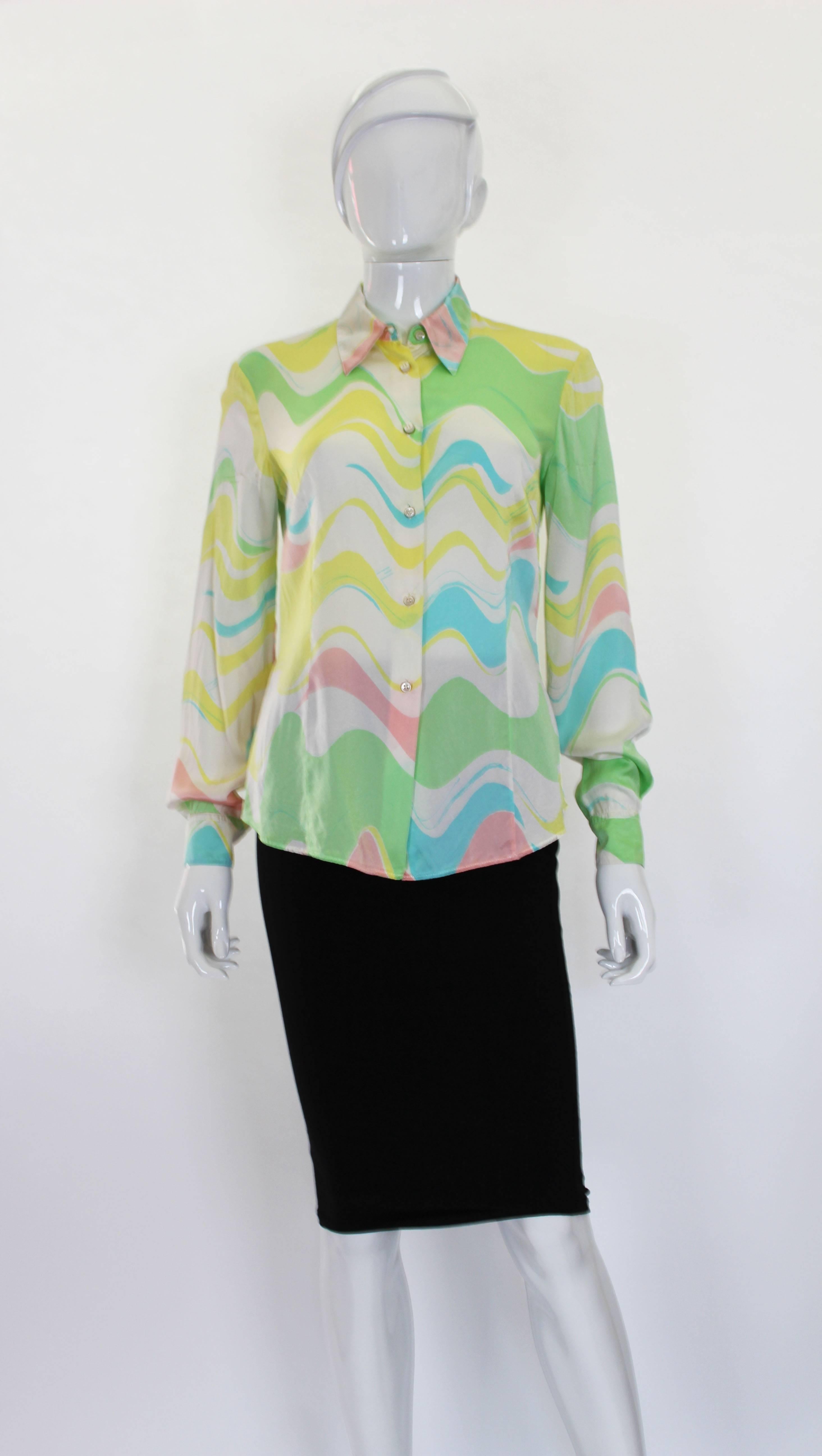 A pretty silk satin  blouse from Italian fashion house Missoni. In a colour palette of a white background, pinks, greens, yellow and blue. The blouse has a 6 button front and button cuffs.
