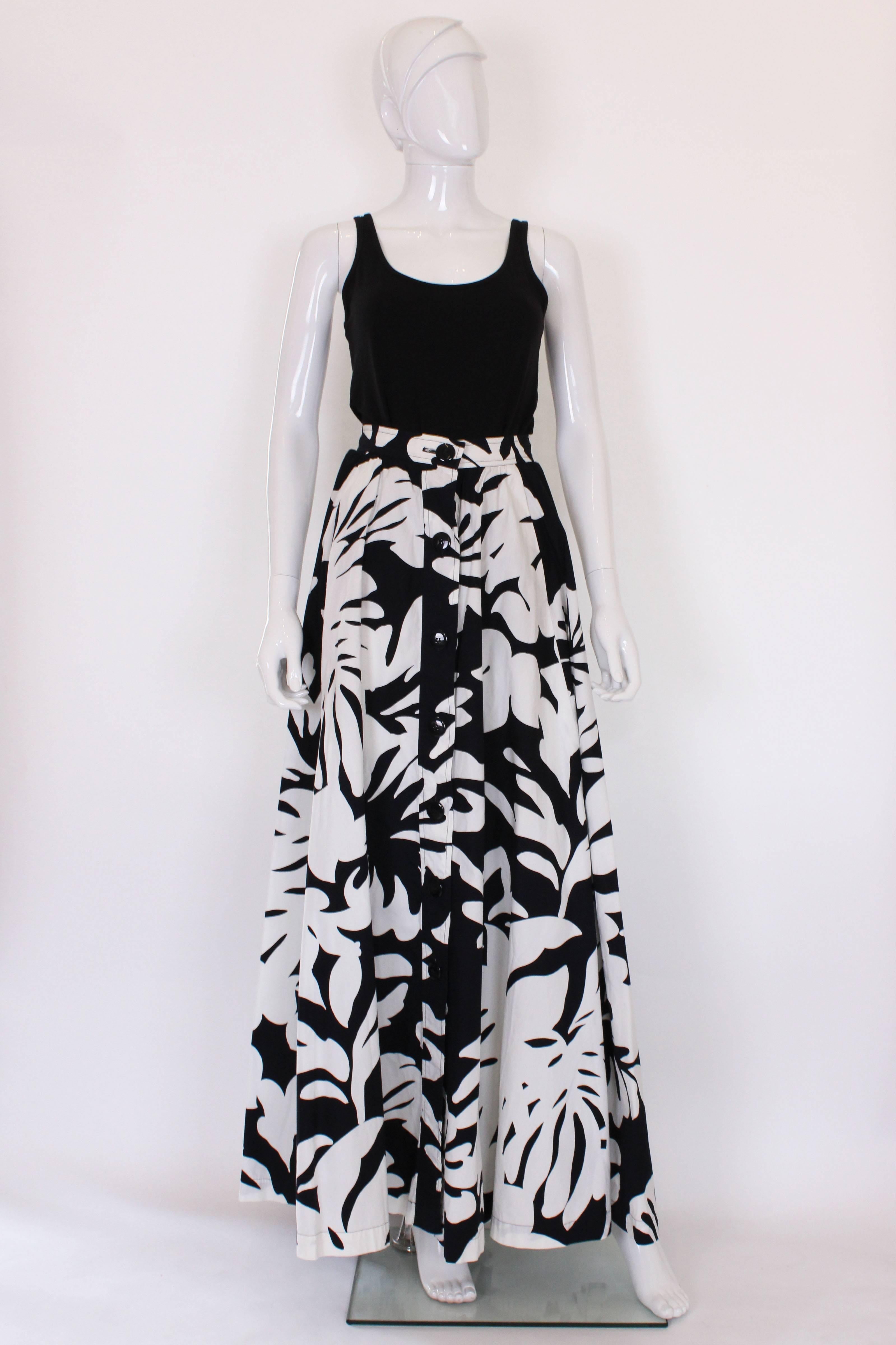 A great skirt from French designer Yves Saint Laurent , Rive Gauche line.
This full length skirt,has a 7 button opening on the front and 2 side pockets.It is a wonderful monochrome black and white print.The skirt is unlined.
