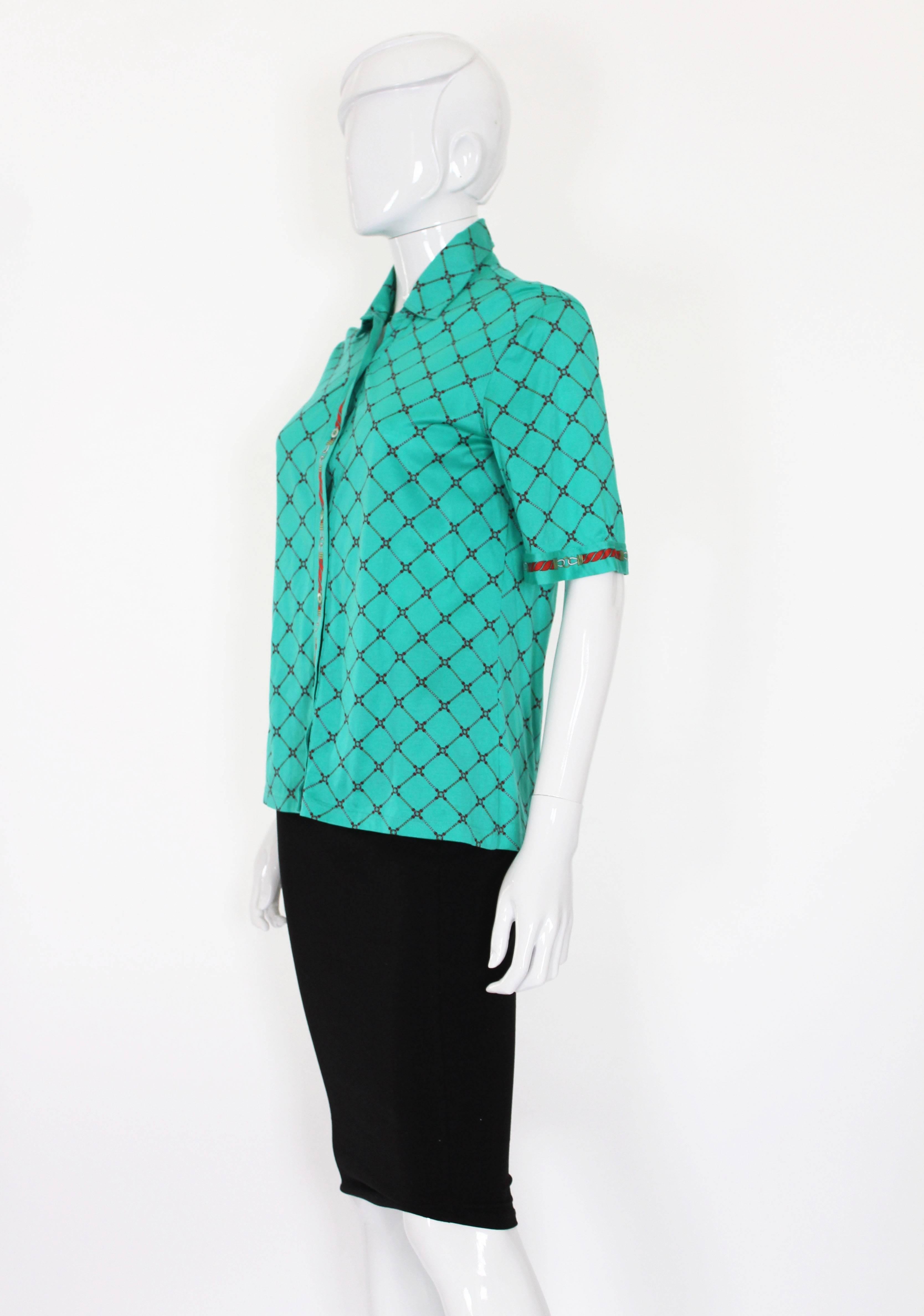 A classic short sleeve shirt by French house ,Celine , Paris.
This shirt is a wonderful green colour with  a rope print design on the body and cuffs. It is 100% cotton, and the buttons are stamped Celine.