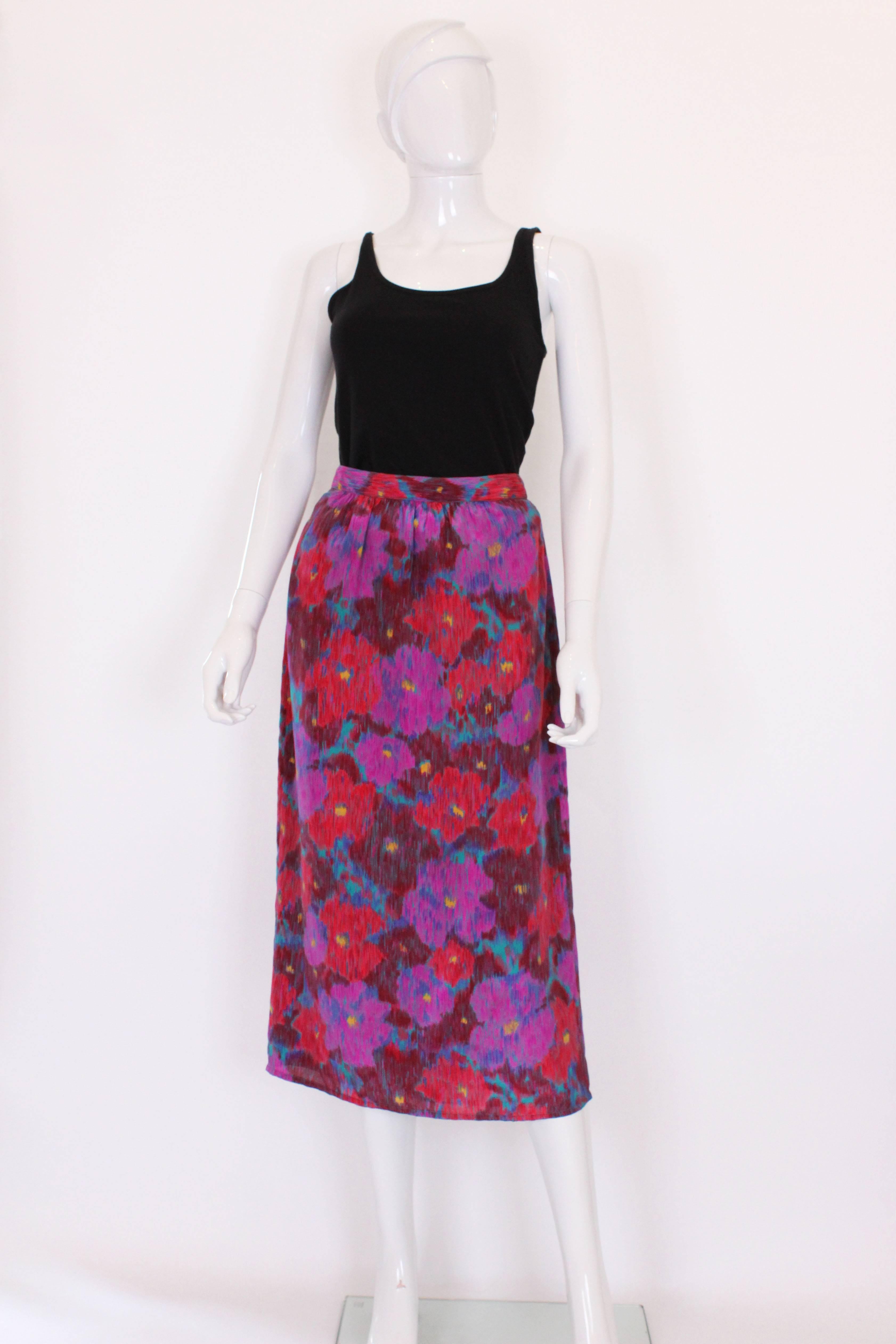 A great skirt for late Summer /Fall. In a multicolour floral print, and  with vertical stripes giving it a contemporary feel. The colours are  great combination, of red, burgundy , purple, blue , and yellow. . The skirt has a back central zip, and