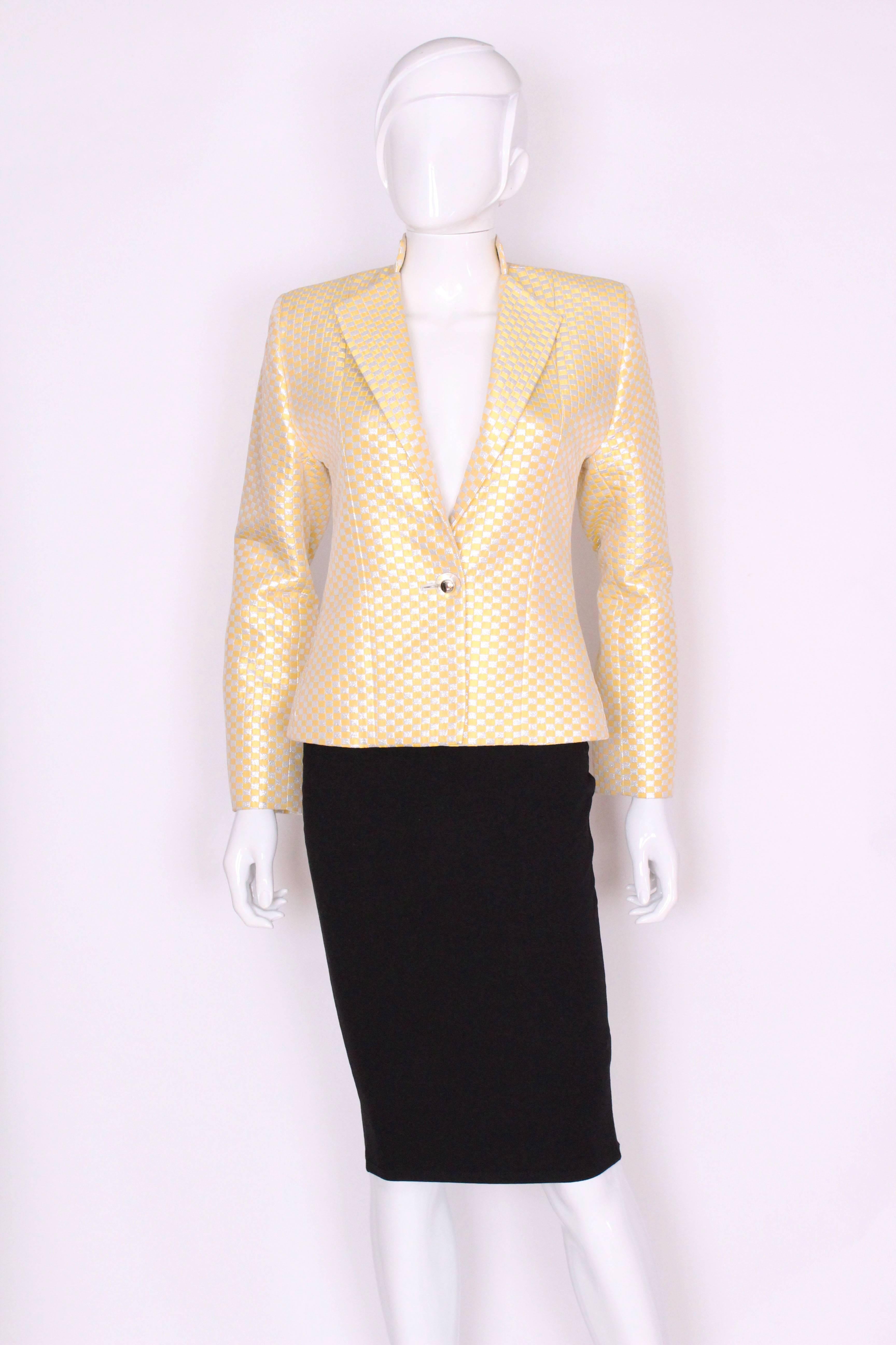A great jacket for Fall/ Winter. This jacket is a great combination of primrose  yellow and silver.It is the variation range for YSL, but still has excellent tailoring, note the seams at the back. It has a stand up collar and lapels, with a one