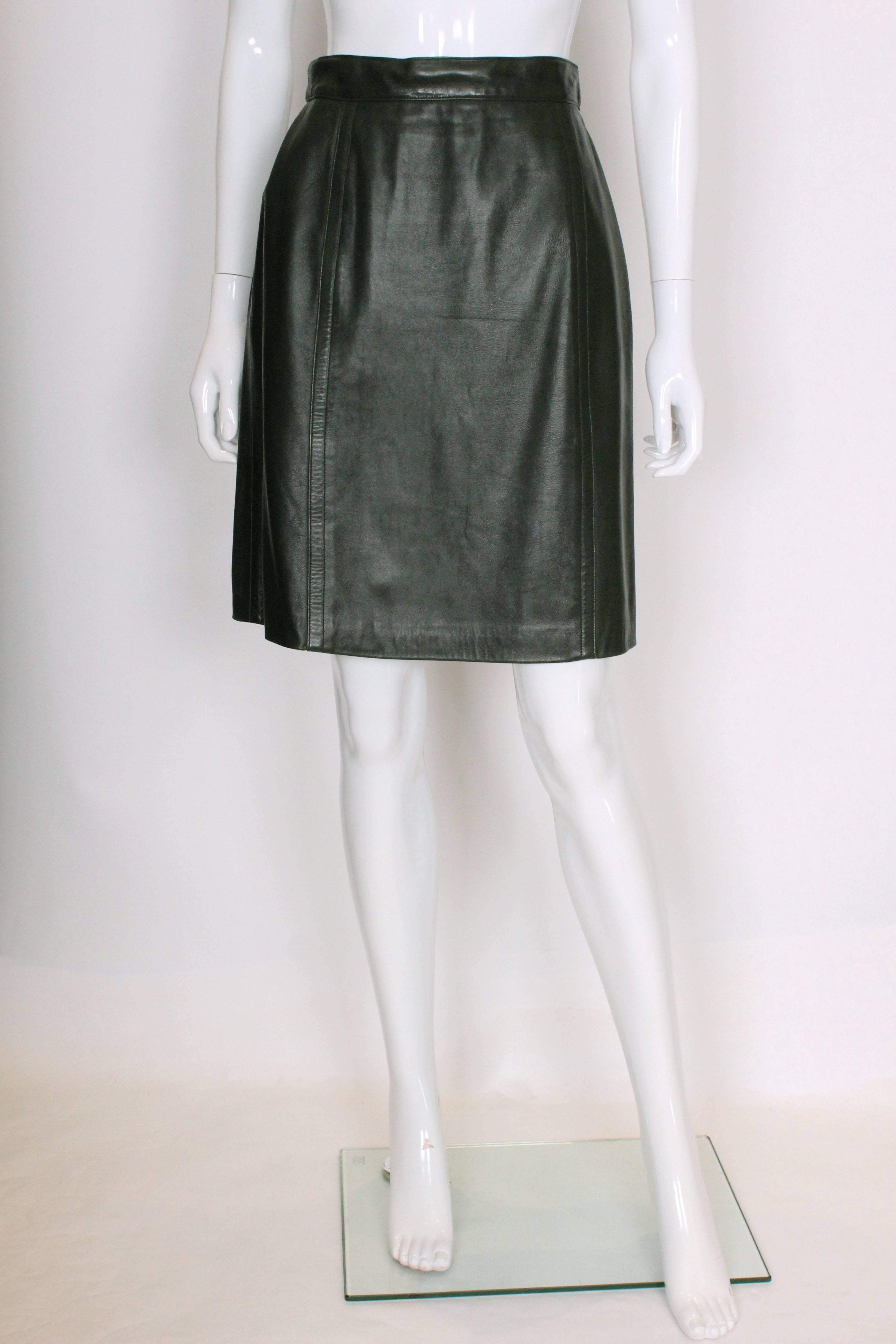 A chic leather skirt by Celine. In a Christmas tree green super soft leather, this skirt is fully lined and has a central back zip