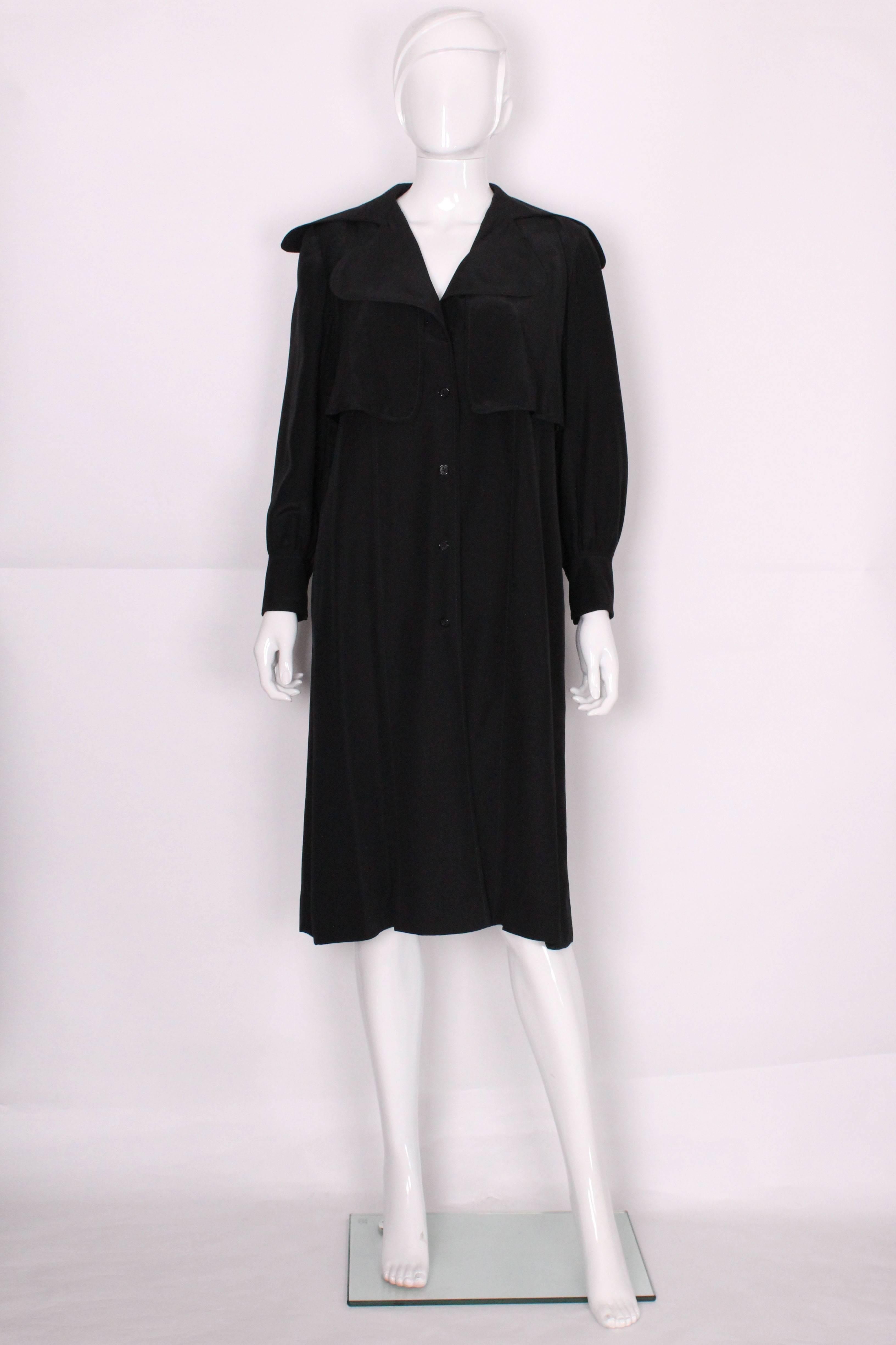 A stunning evening coat/opera coat by Bill Gibb London.This coat is easy to wear. It has a gathered yoke at the back ,neatly covered by a two button feature.It has a v neckline, four button fastening, gathered sleeves with a two button cuff. There