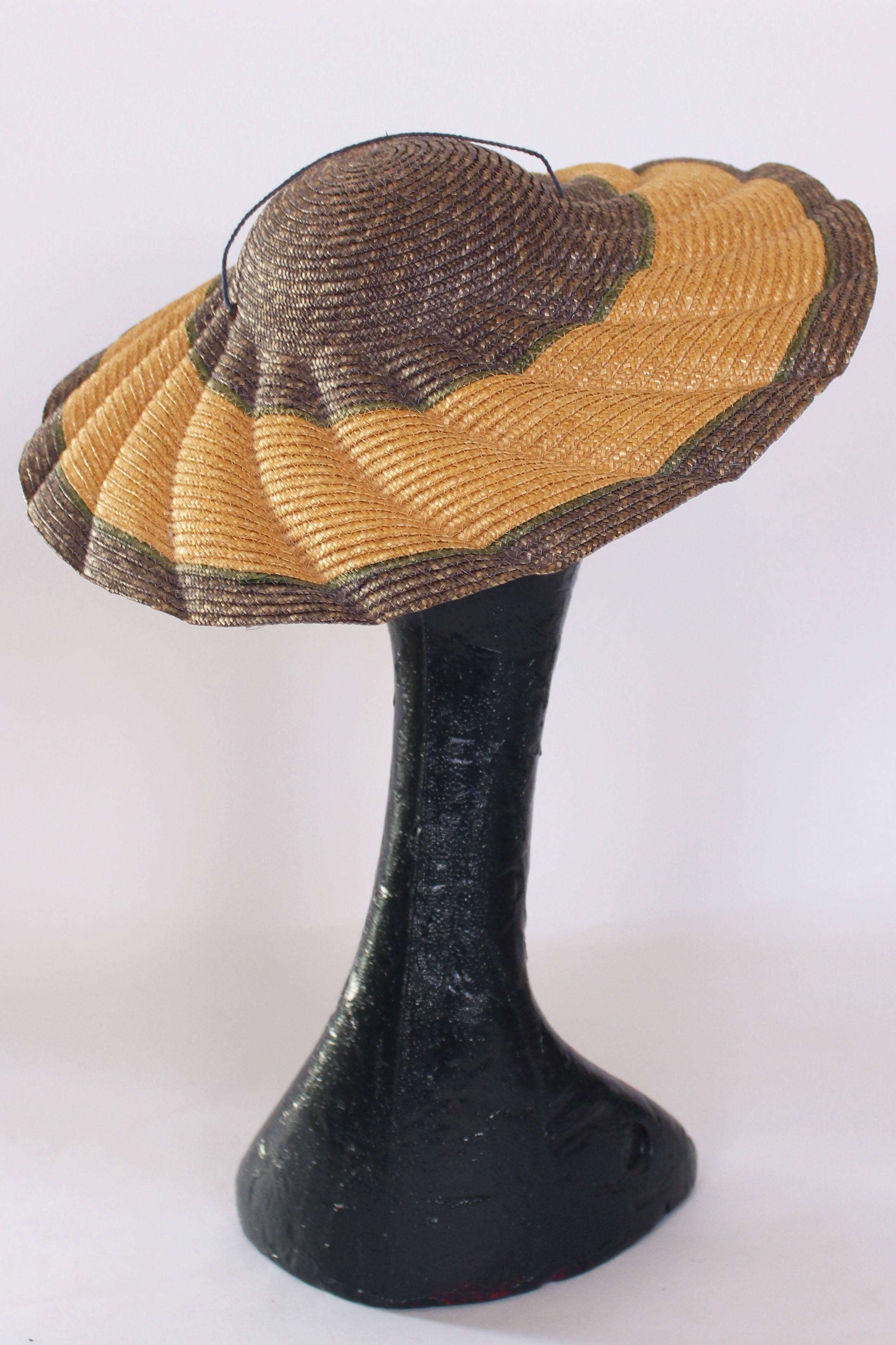 This would be a great hat for a wedding or summer events. The hat is a wonderful mix of soft colours; mauve, green and natural stripes. The sape is  lovely scalloped brim which looks like waves. It has quite a shallow crown so has a ribbon/string