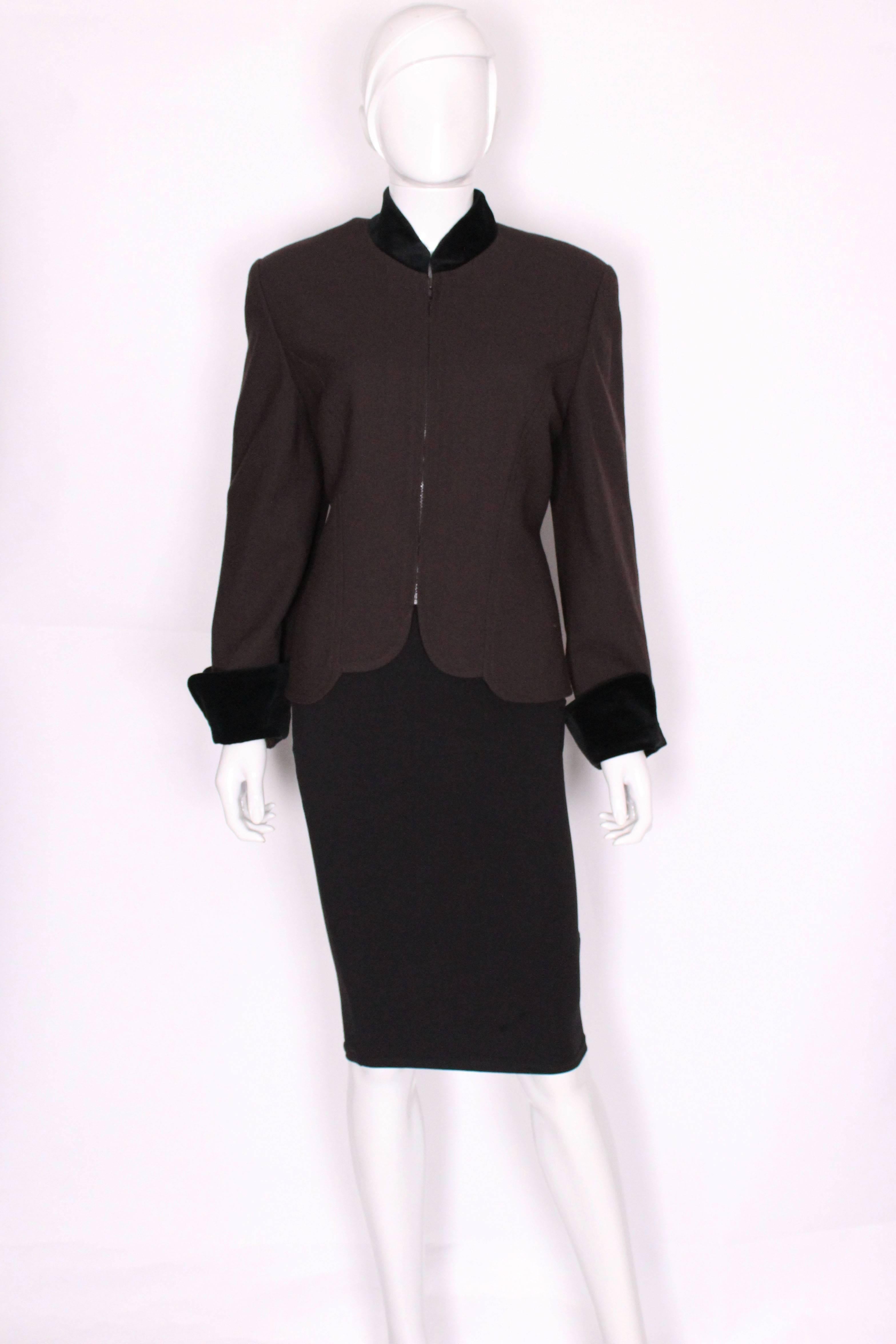 A great jacket by Christian Dior. In a brown wool crepe with soft velvet edging to the collar and turn back cuffs. The jacket has a zip opening at the front, and scallop detail on the front hem.