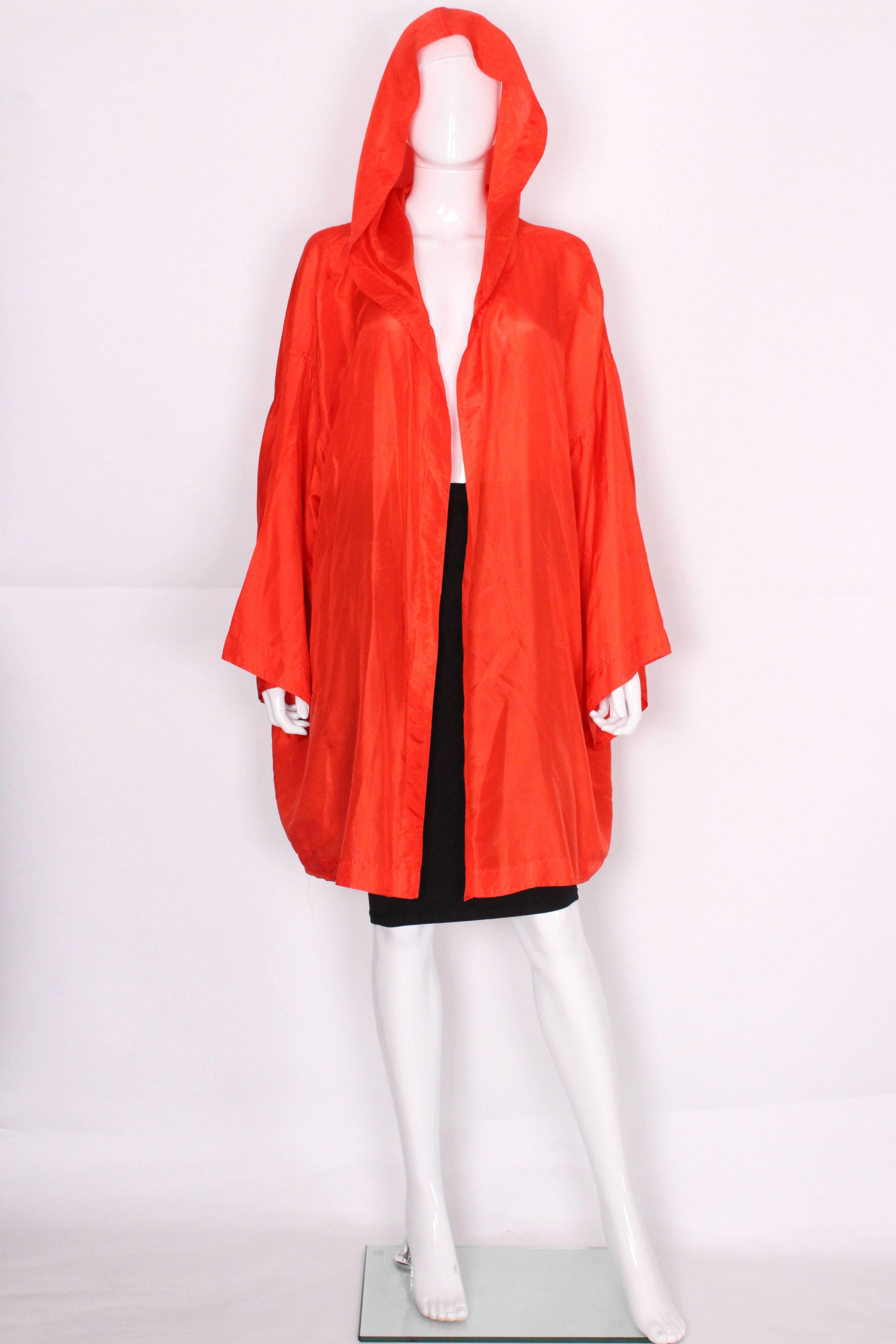 A great silk oversize jacket by Isacc Mizrahi. In a lovely tomato red silk, one size fits all etc, this jacket is great for wearing over sport or vacation wear. Will fit a bust size up to 52''.