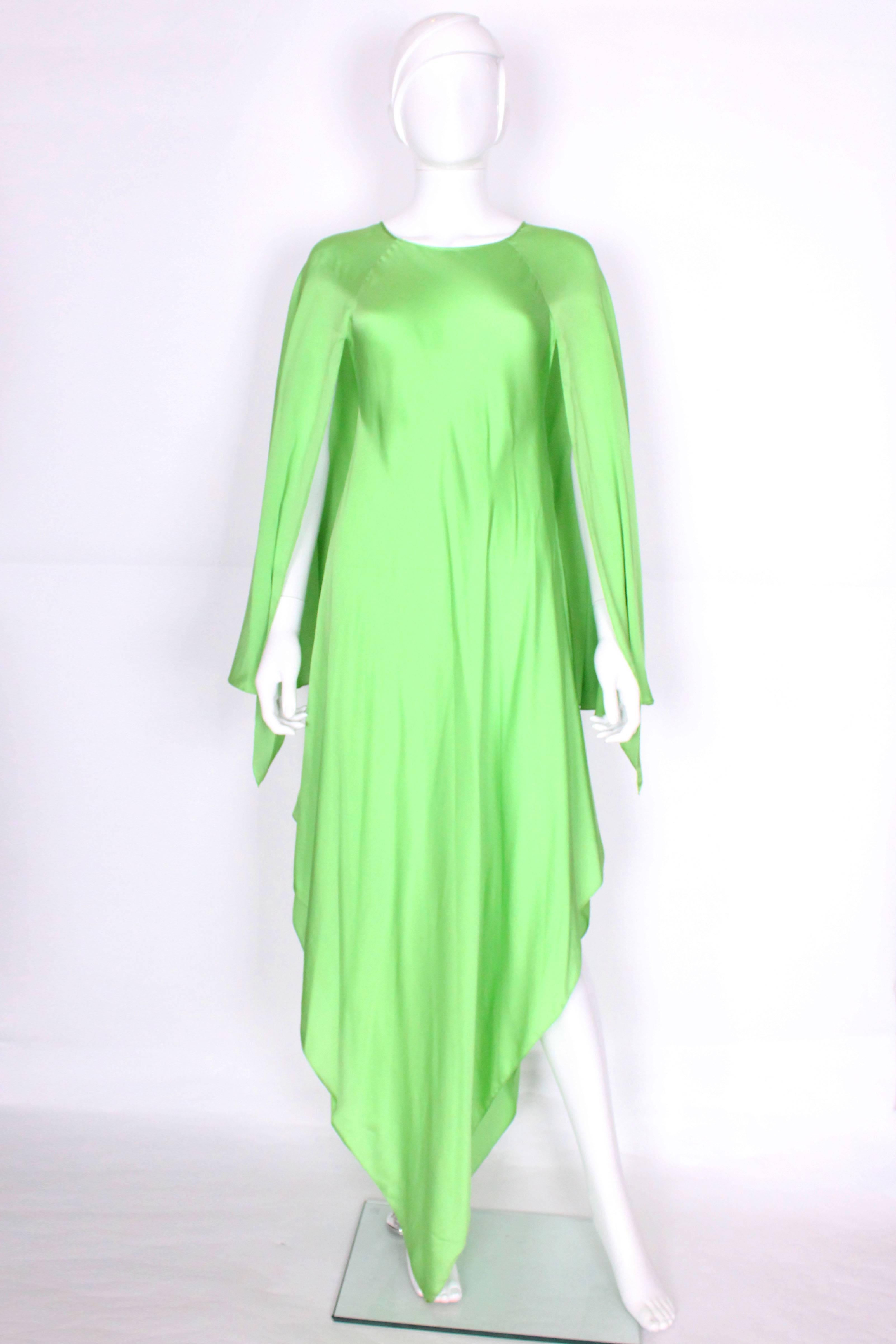 This green silk gown, by the late US designer Oscar de la Renta, is a real head turner. In a super soft silk ,  with angel sleeves and a pointed hem, it is easy to wear and accessorize.