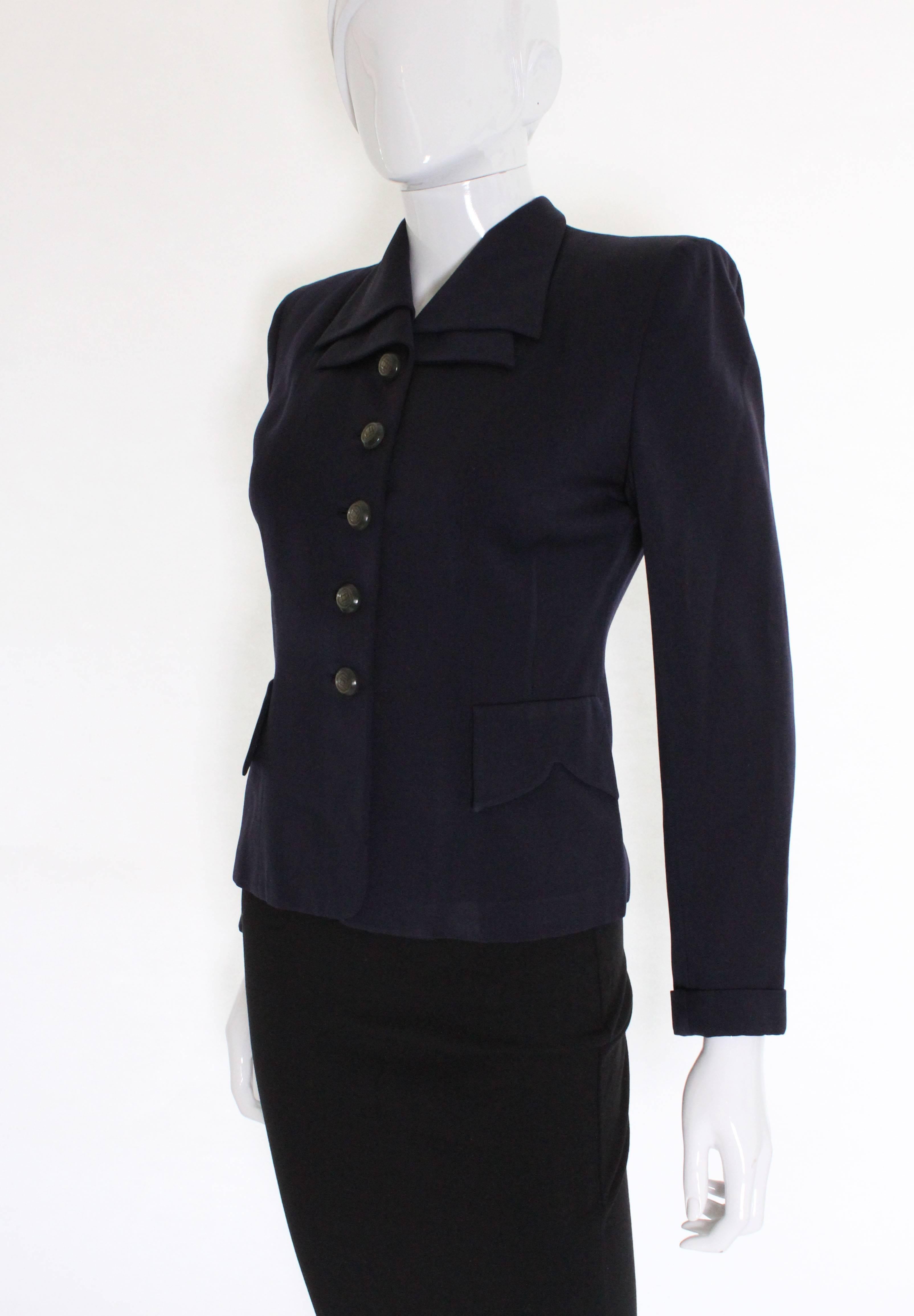 A vintage dark navy classic 1940s double collar detail jacket, made of rayon. It has faux pocket flaps on the waist at either side, which have a decorative petal shape. The back of the collar also has a lovely shape that is in 2 sections and crosses