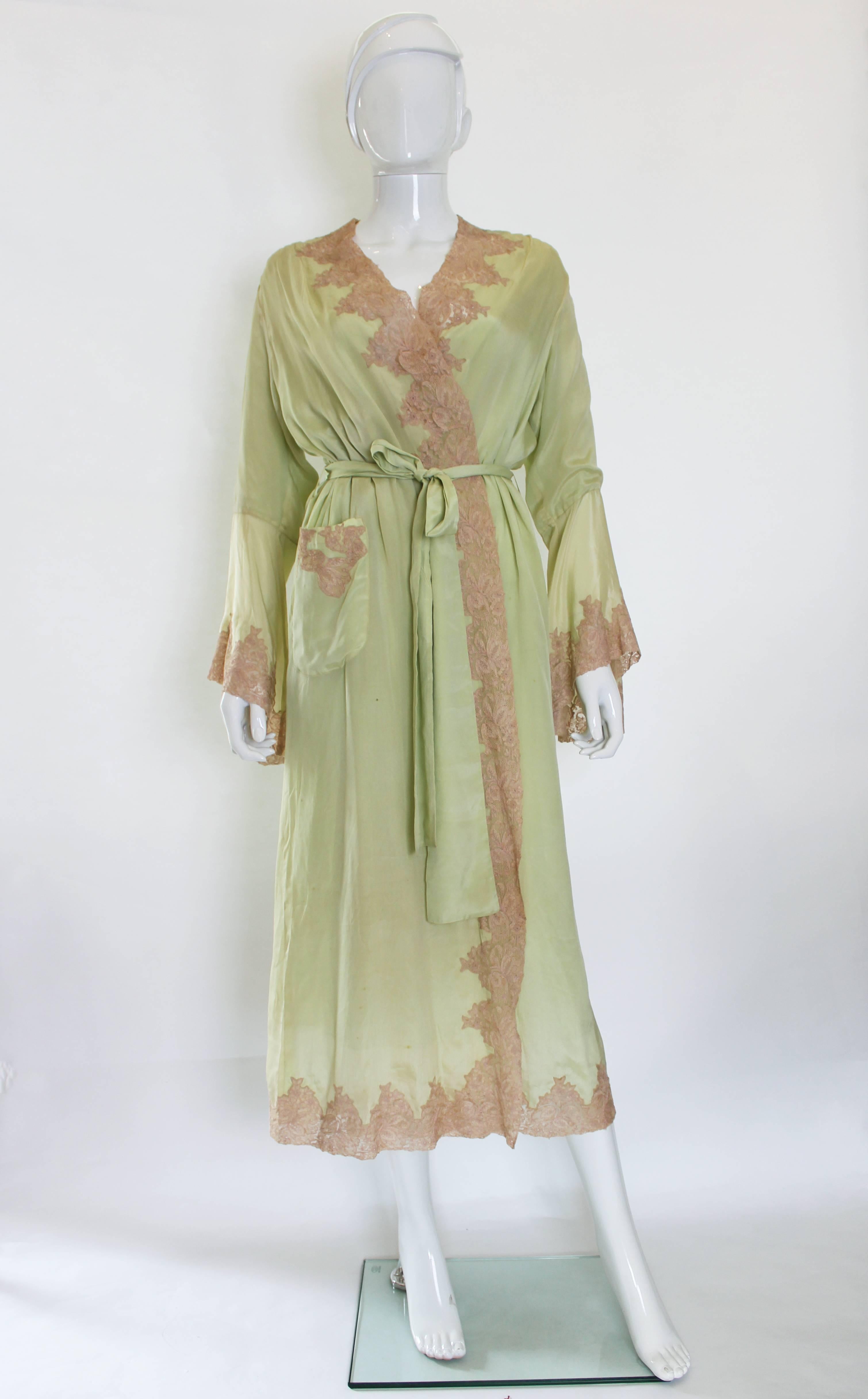 A stunning full length negligee in pistachio green silk, with biscuit coloured lace trim. The negligee is fully lined in silk, so it hangs beautilfuly. There is in internal tie belt and a 4 inch wide belt around the gown. The lace trim is around the