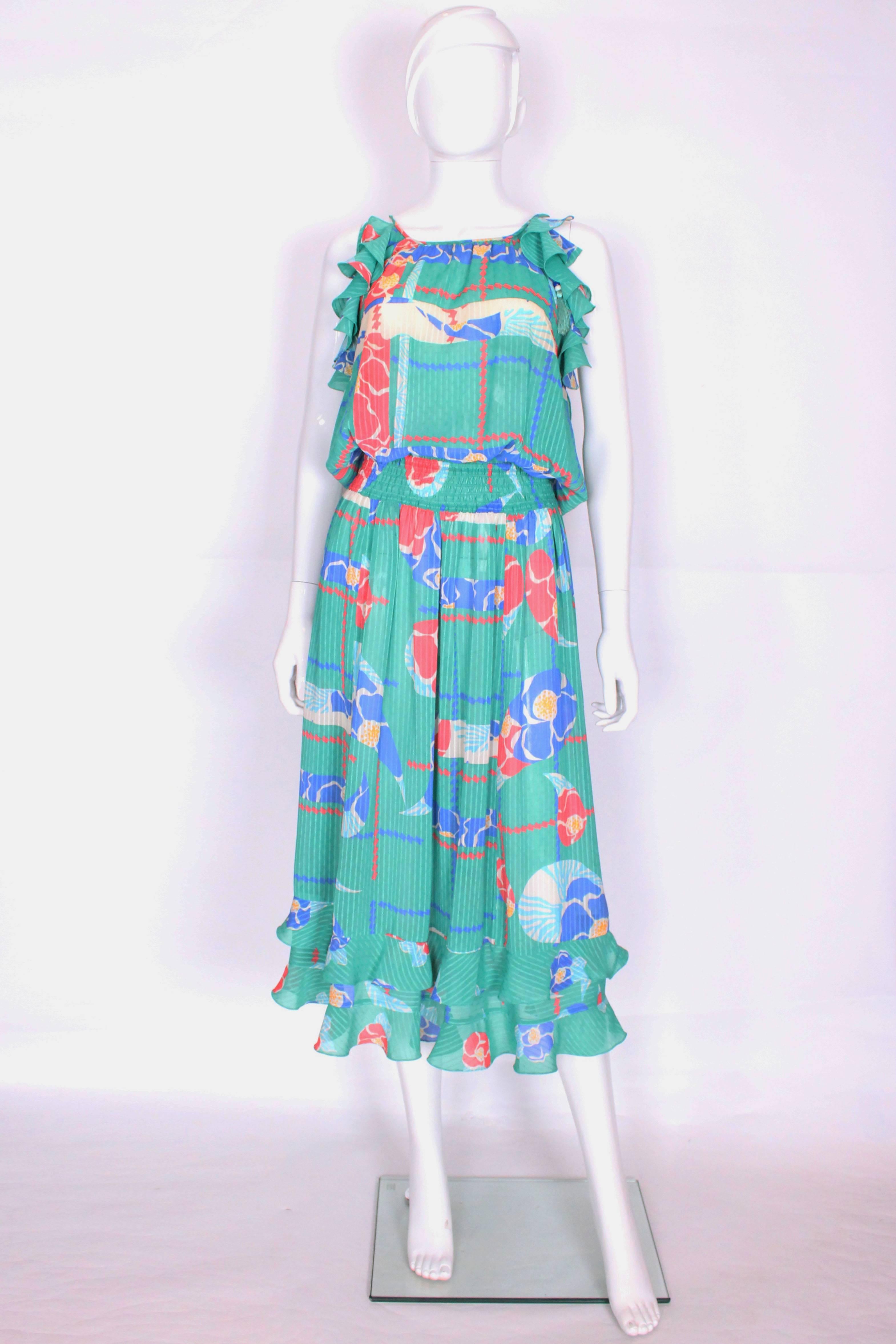 A fabulous dress by Diane Fres. This dress has a sea green background with stripe detail, and a floral print in salmon pink,blue and ivory. The dress has an elasticated waist for easy wear, and two rows of frills at the hem, and armholes.
It doesnt 