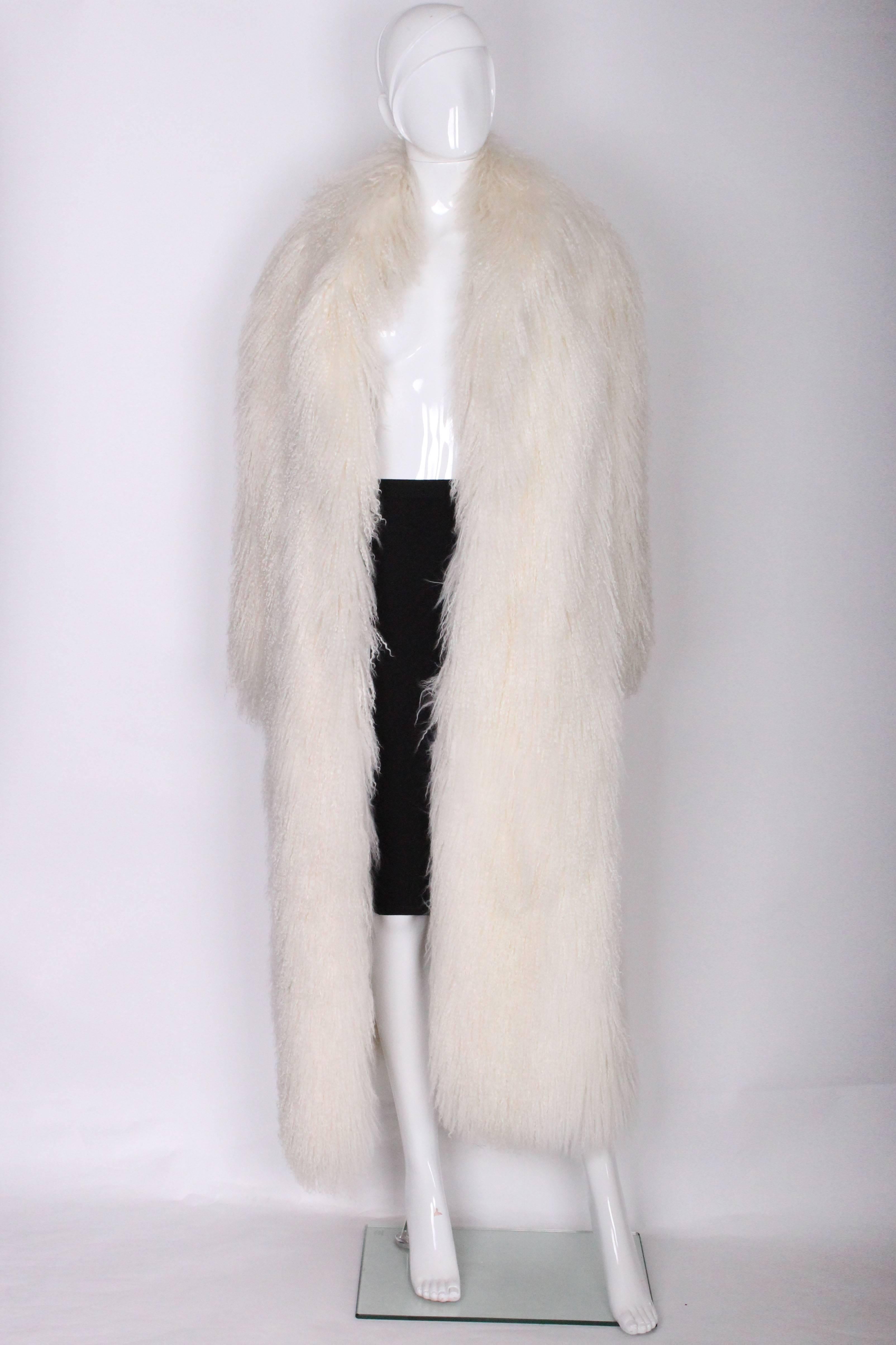 A great and groovy fur coat.In white Mongolian lamb fur, this coat is easy to wear and not too heavy.