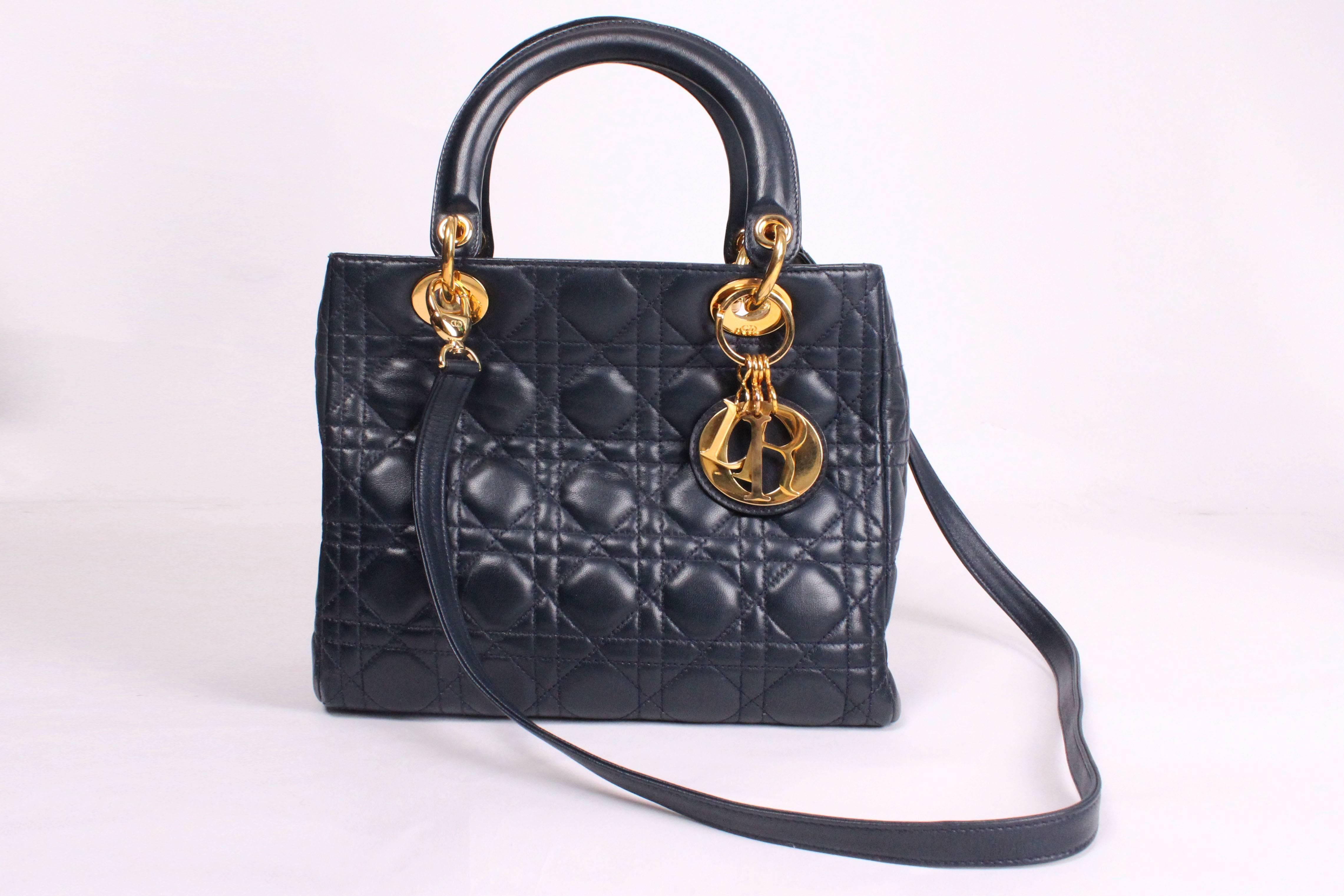 A chic Dior D bag in navy blue leather. This bag is in excellent condition, and has all the original hardwear. The bag is lined in red,and has an internal zip pocket, and detachable 35''shoulder strap.The bag has a top central zip closure.