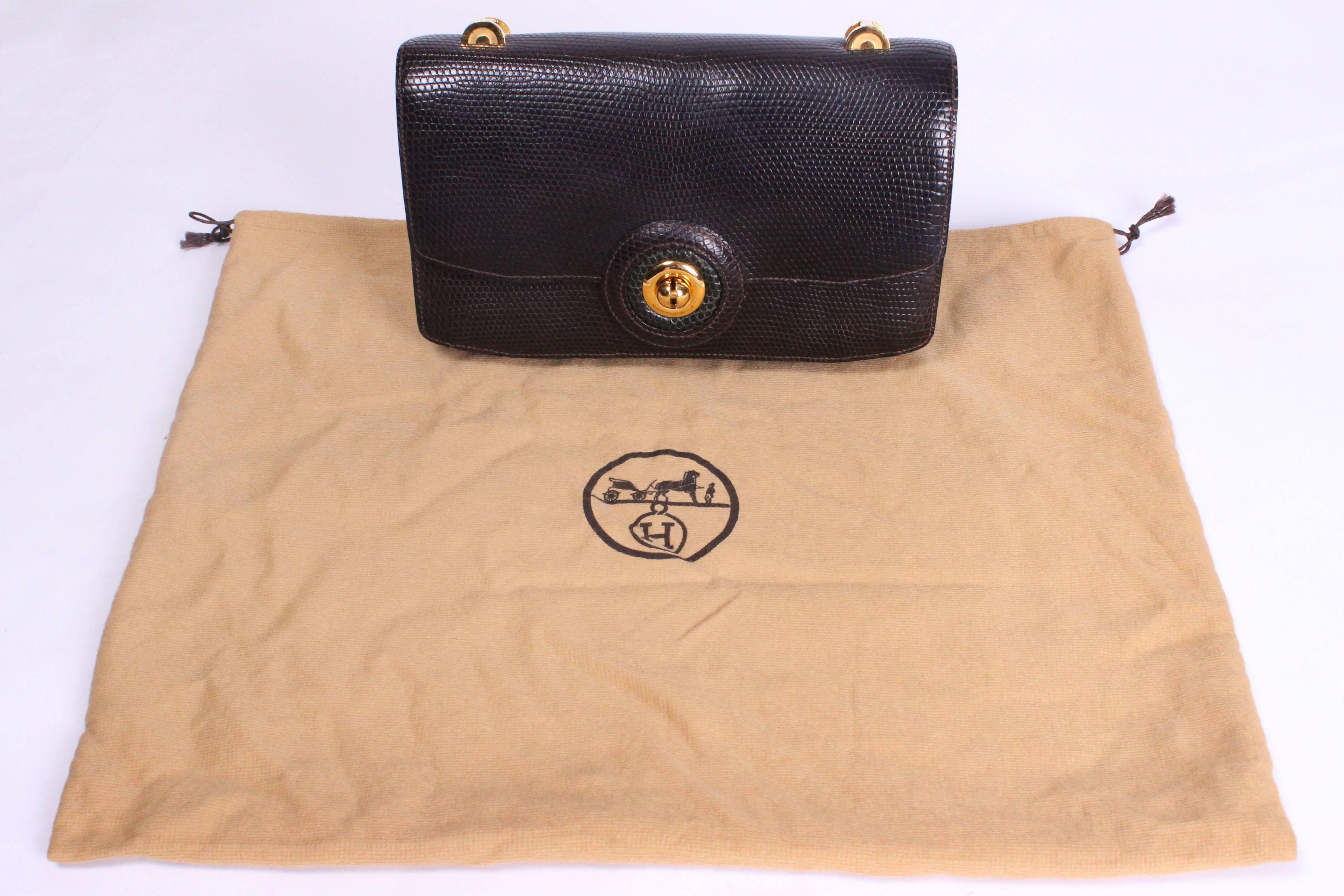 A chic snakeskin bag by Hermes. This bag is in brown snakeskin ,and lined in super soft brown leather.It has a front flap opening with a gold catch surrounded by a circle of green snakeskin. Inside there are three compartments,one with a popper