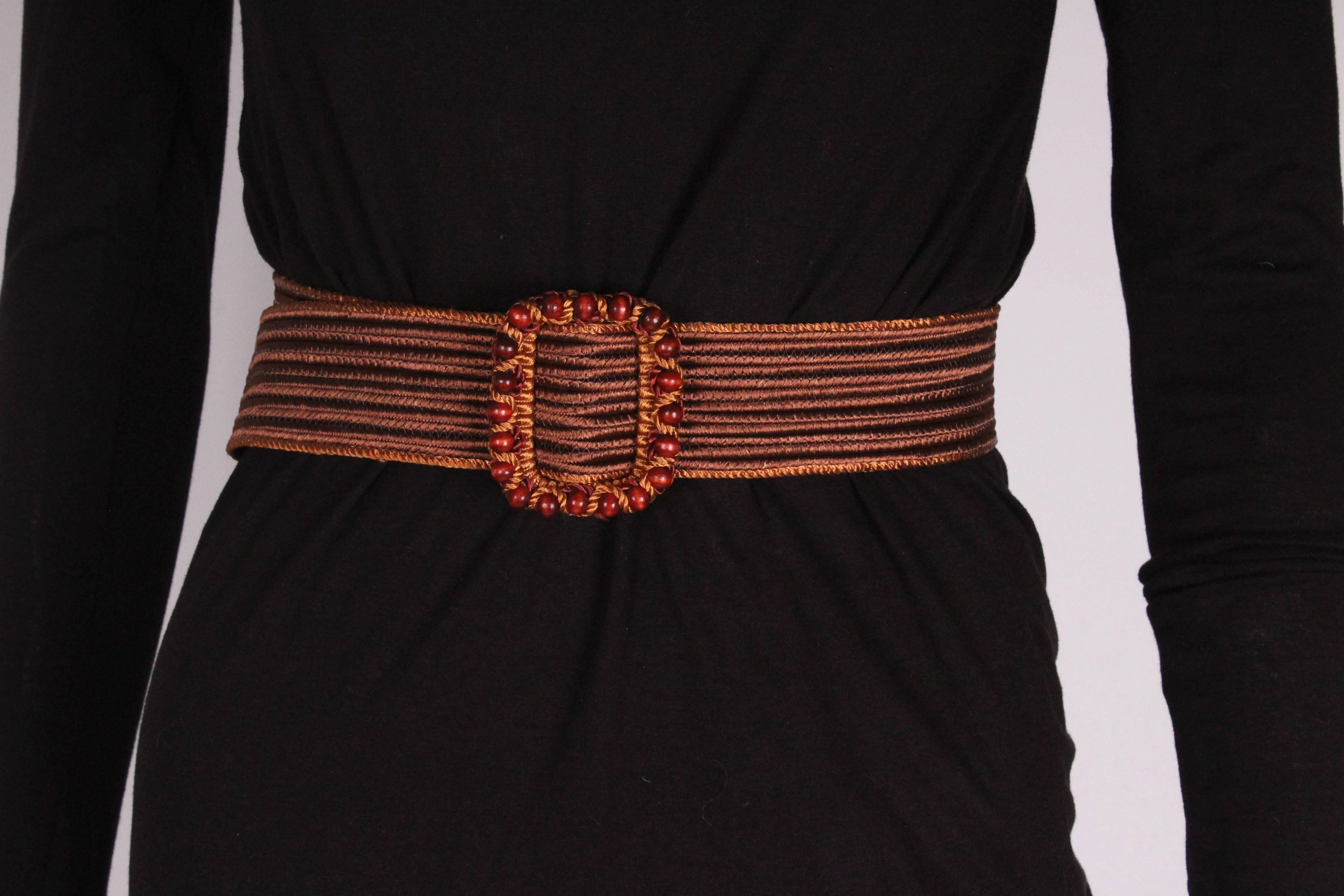 A great belt for Spring, in a dark brown woven silk with tan edging. The buck has bead detail. The belt pulls through , so can fit most sizes.
Length 34'' , height 2''