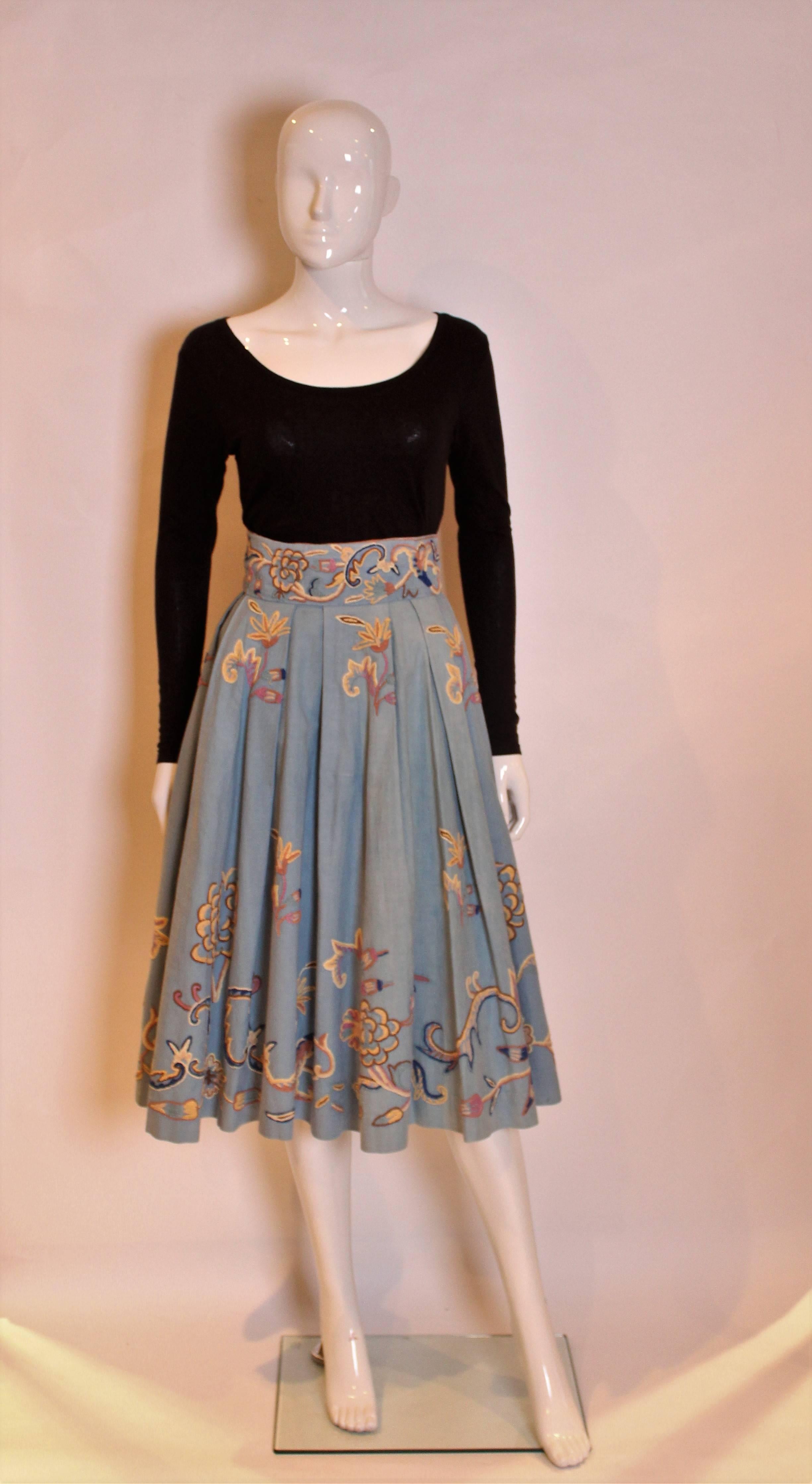 A great skirt for Spring/Summer. In a heavy blue cotton with wonderful embroidery and a great swish when you walk.The skirt has pleats at the waist band and wonderful embroidery in blue, beige, pink and blue.There is a central back zip, and the