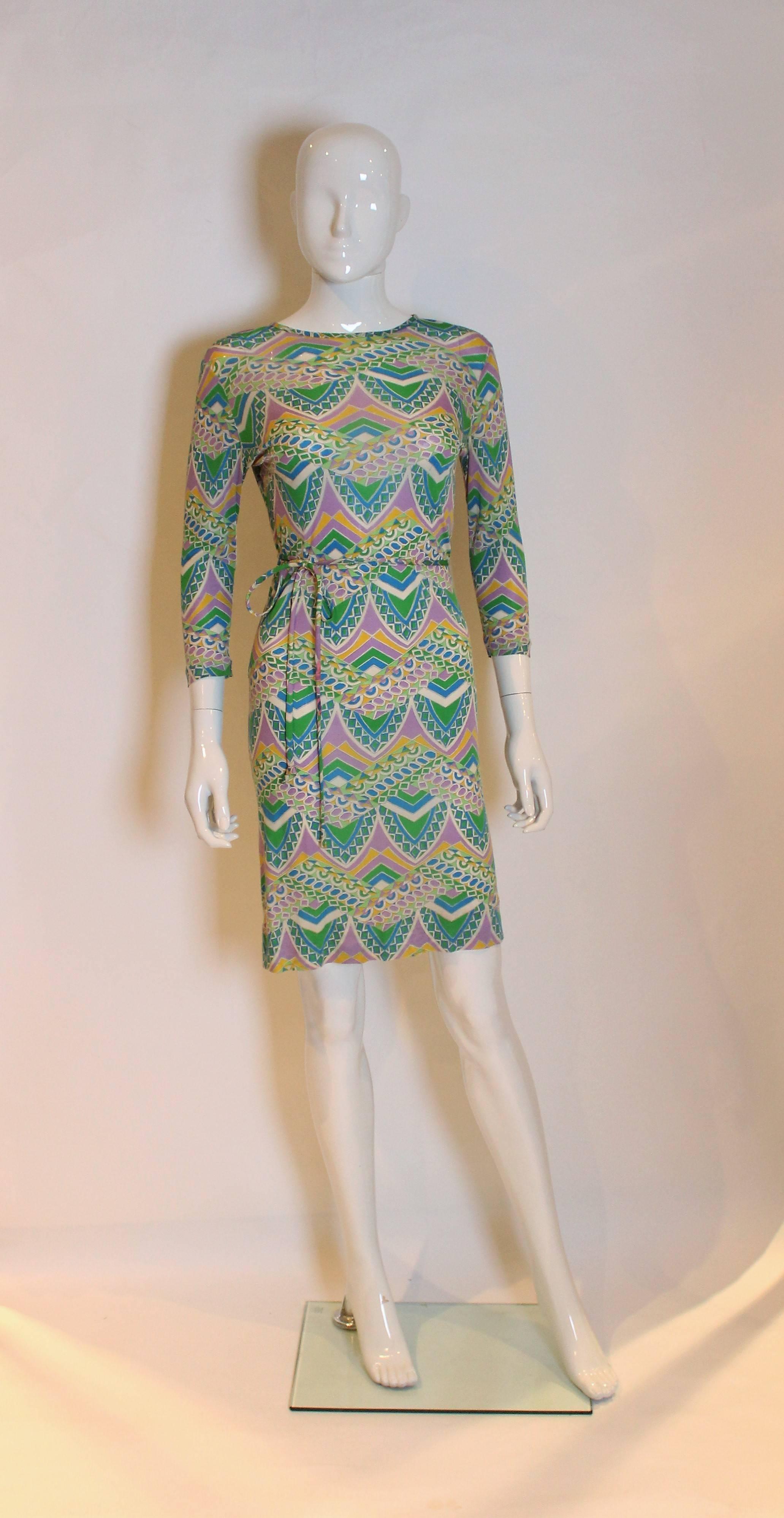 A great dress for  Spring. Easy to wear in a super soft silk jersey, this dress is a multitude of colours and has elbow length sleeves and a self fabric tie belt.