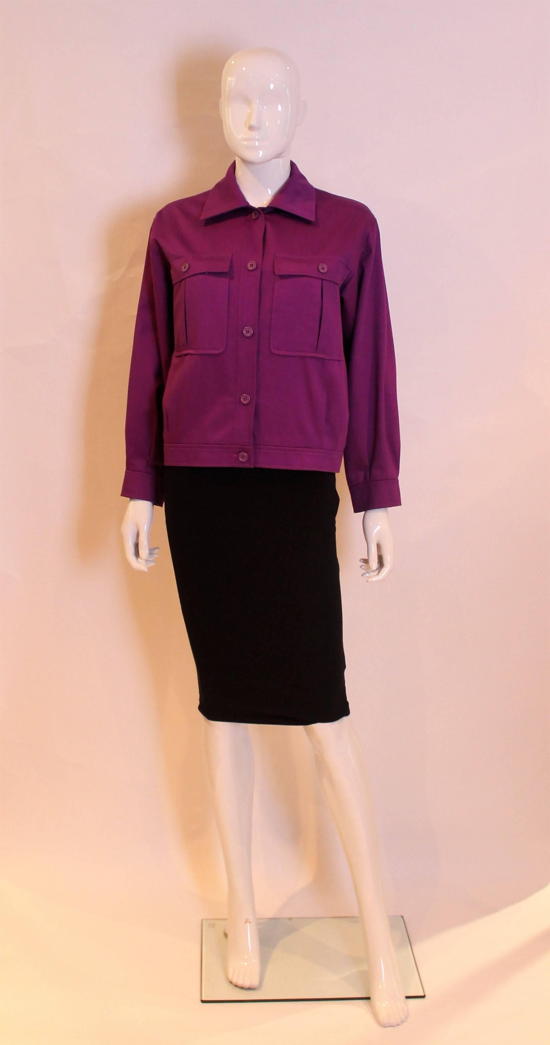 A chic bomber style jacket by Yves Saint Laurent Rive Gauche. In a striking purple colour,this jacket has two breast pockets with buttons, a five button central opening and single button cuffs.