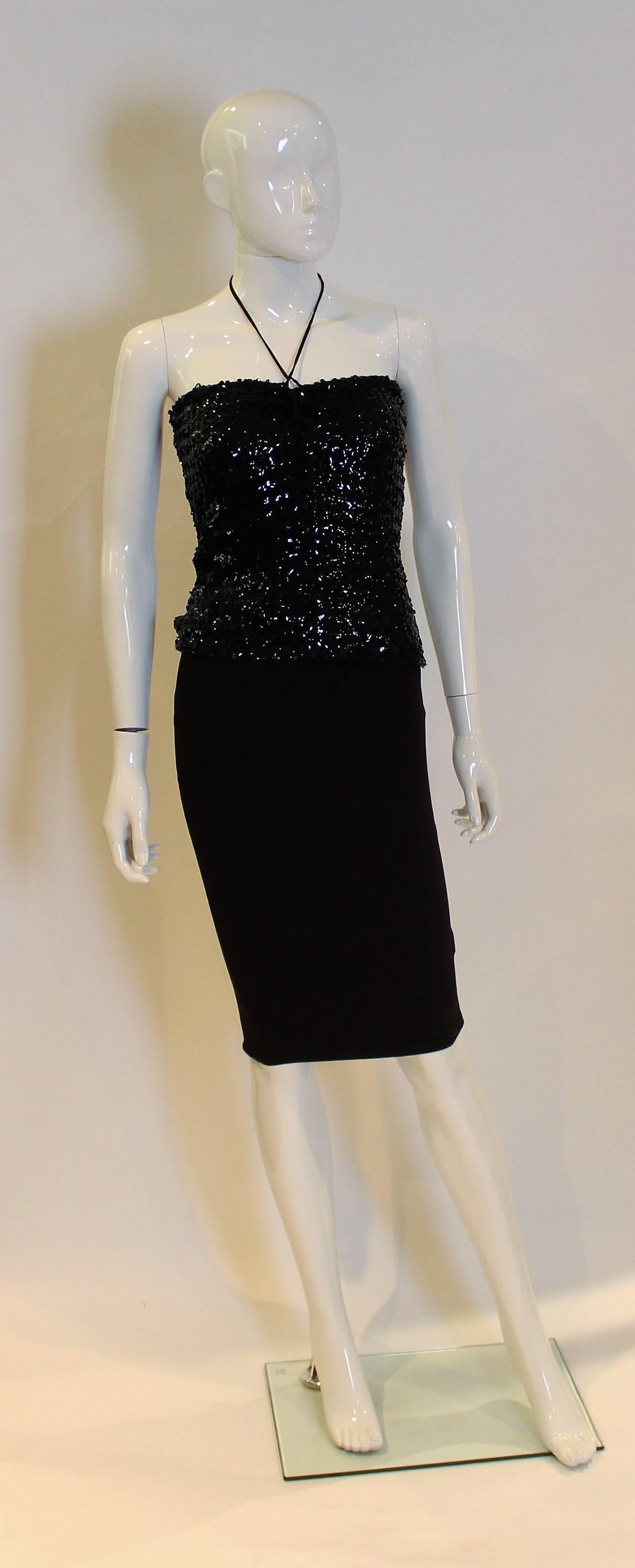 A great vintage sequin top by Biba. In a black stretchy fabric ( will stretch to about bust 34'') this top has ties at the front centre,to create a halter neck.